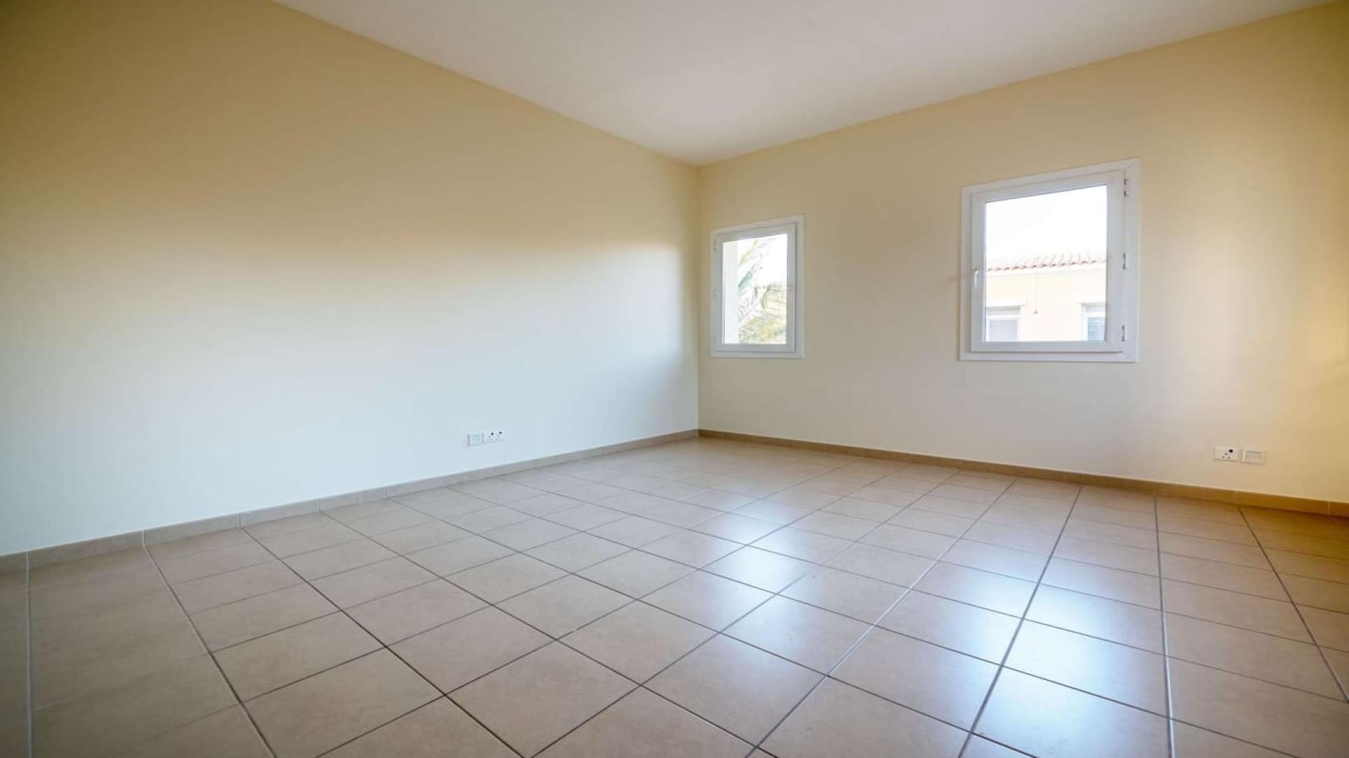 Spacious living room in 4-bedroom villa, Palmera 4, Arabian Ranches, with large windows and patio