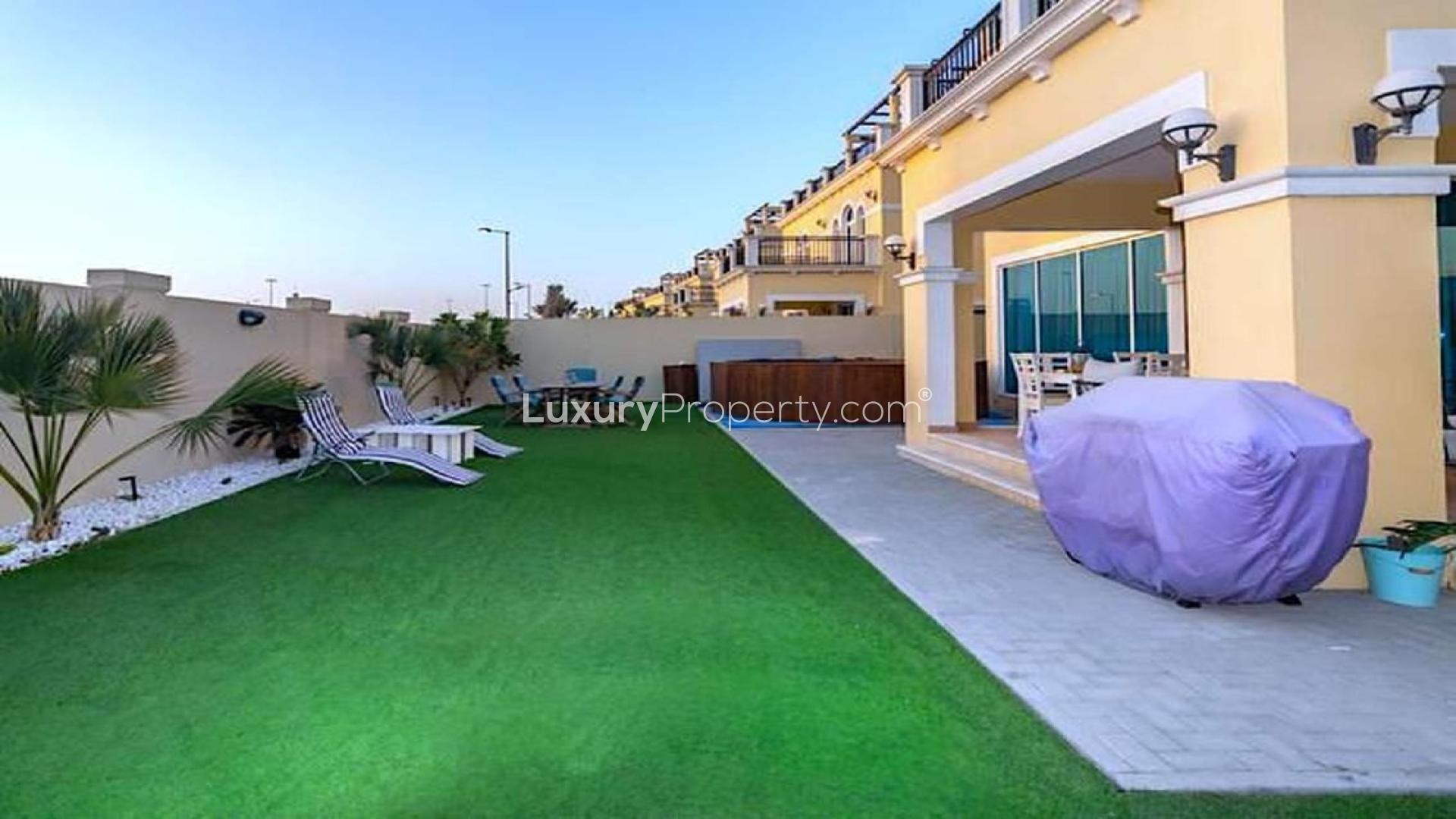 "Elegant 4-bedroom Legacy Nova Villa exterior in Jumeirah Park, available for rent.",Spacious backyard with lawn and patio in Jumeirah Park Legacy Nova Villa for rent