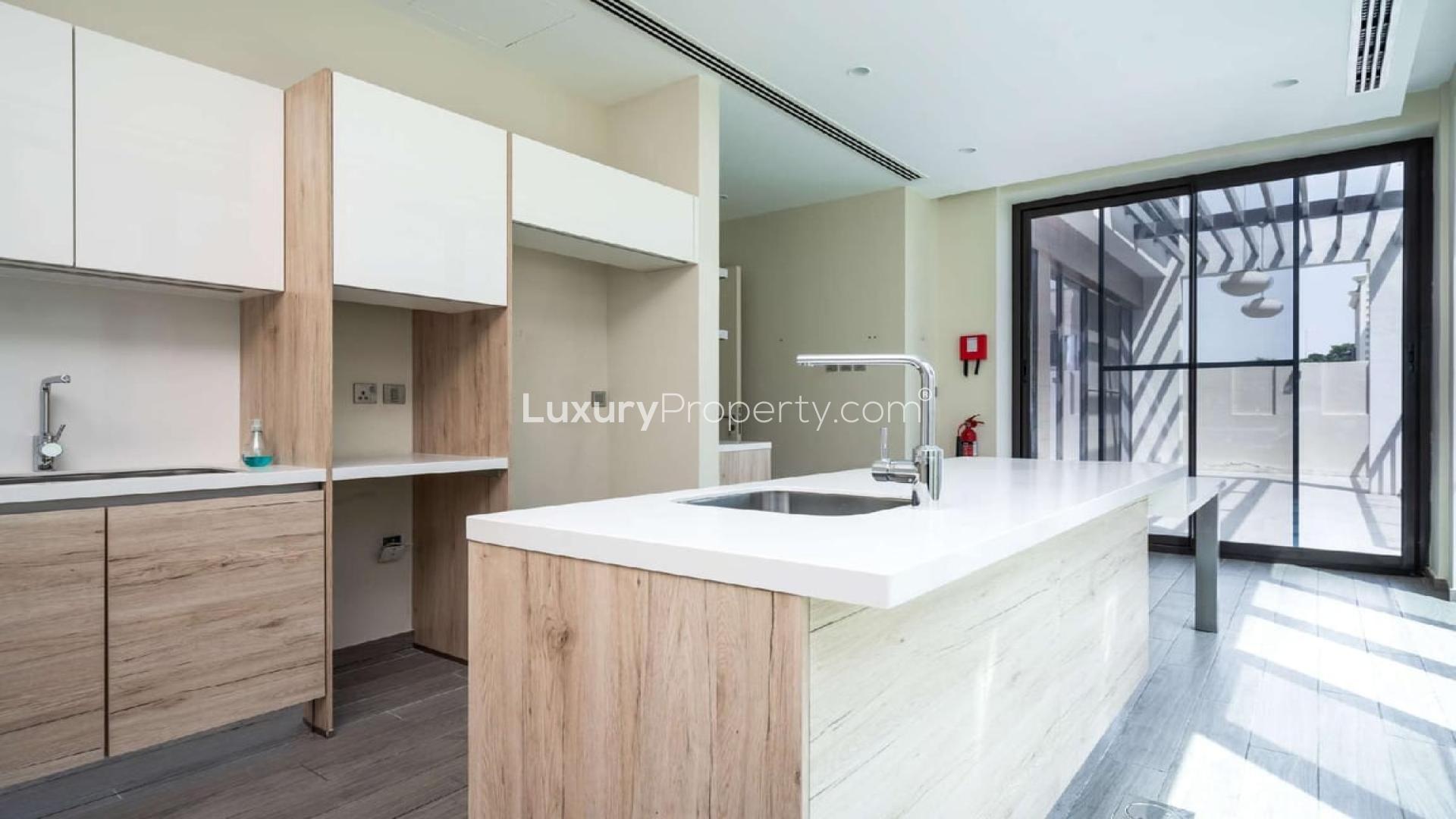 Contemporary open-plan living area in 4-bedroom villa, Umm Suqeim 2, with modern staircase