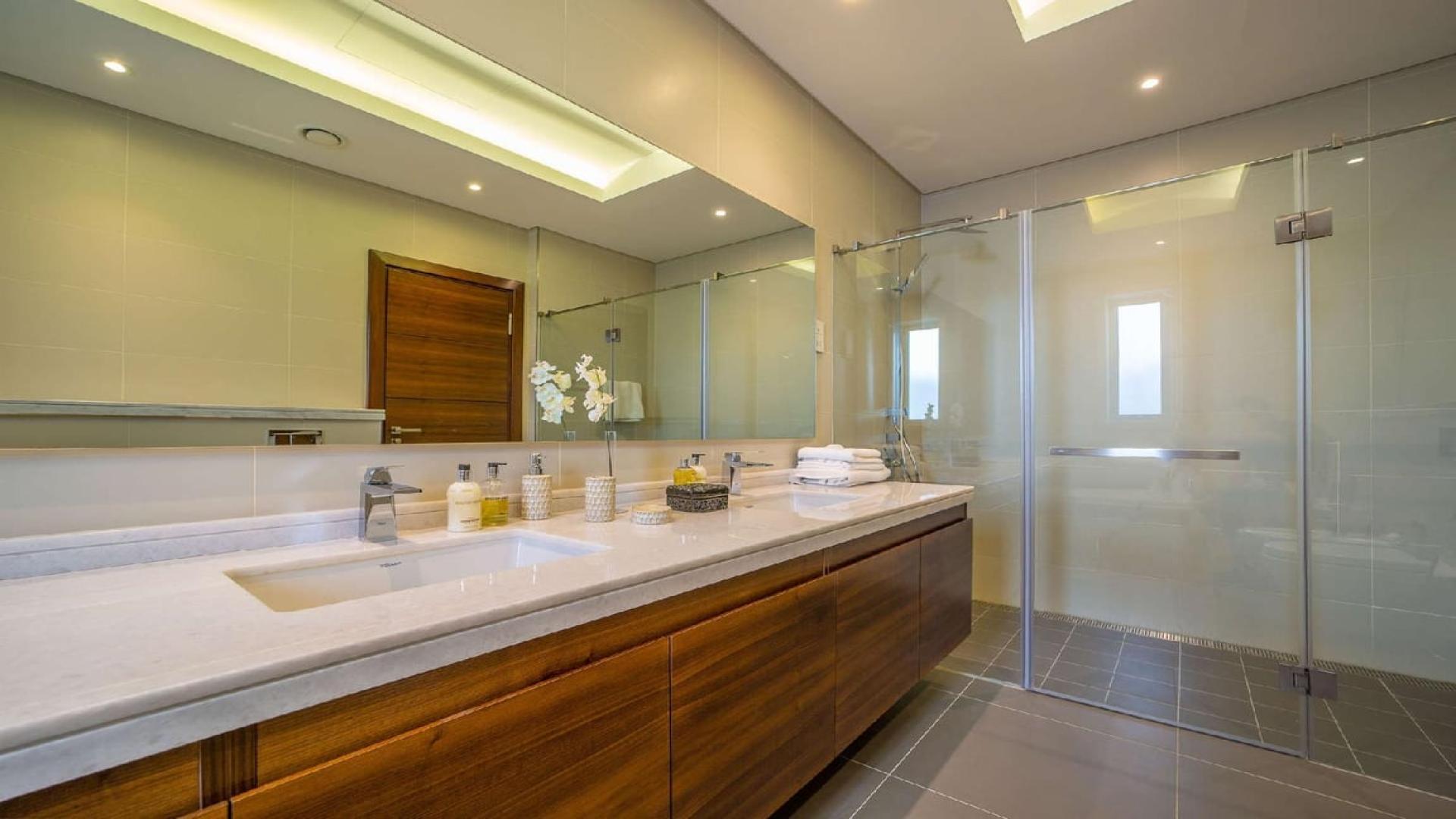 Contemporary villa living room in District One, MBR City, with modern furniture and glass doors