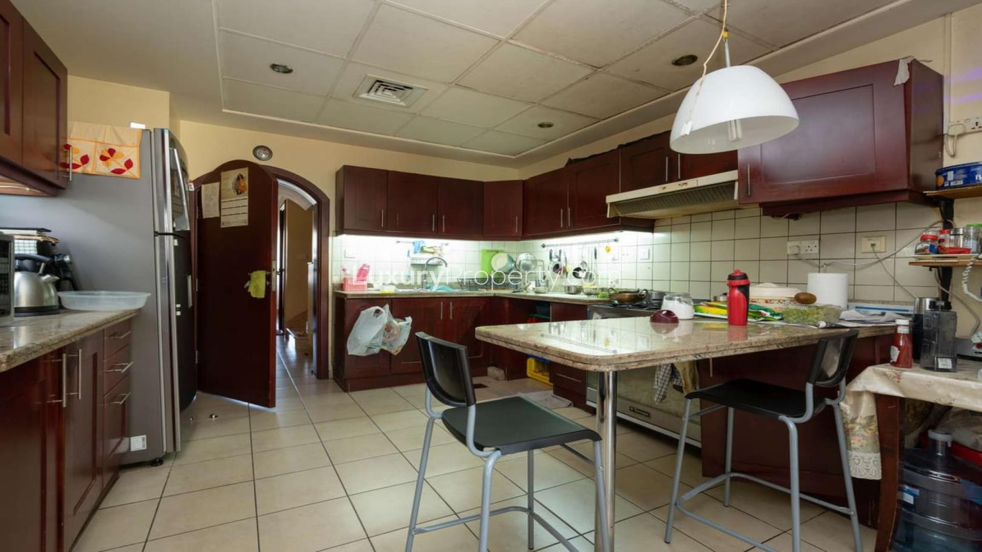 Sunlit dining area with garden view in upgraded Al Reem villa, Arabian Ranches
