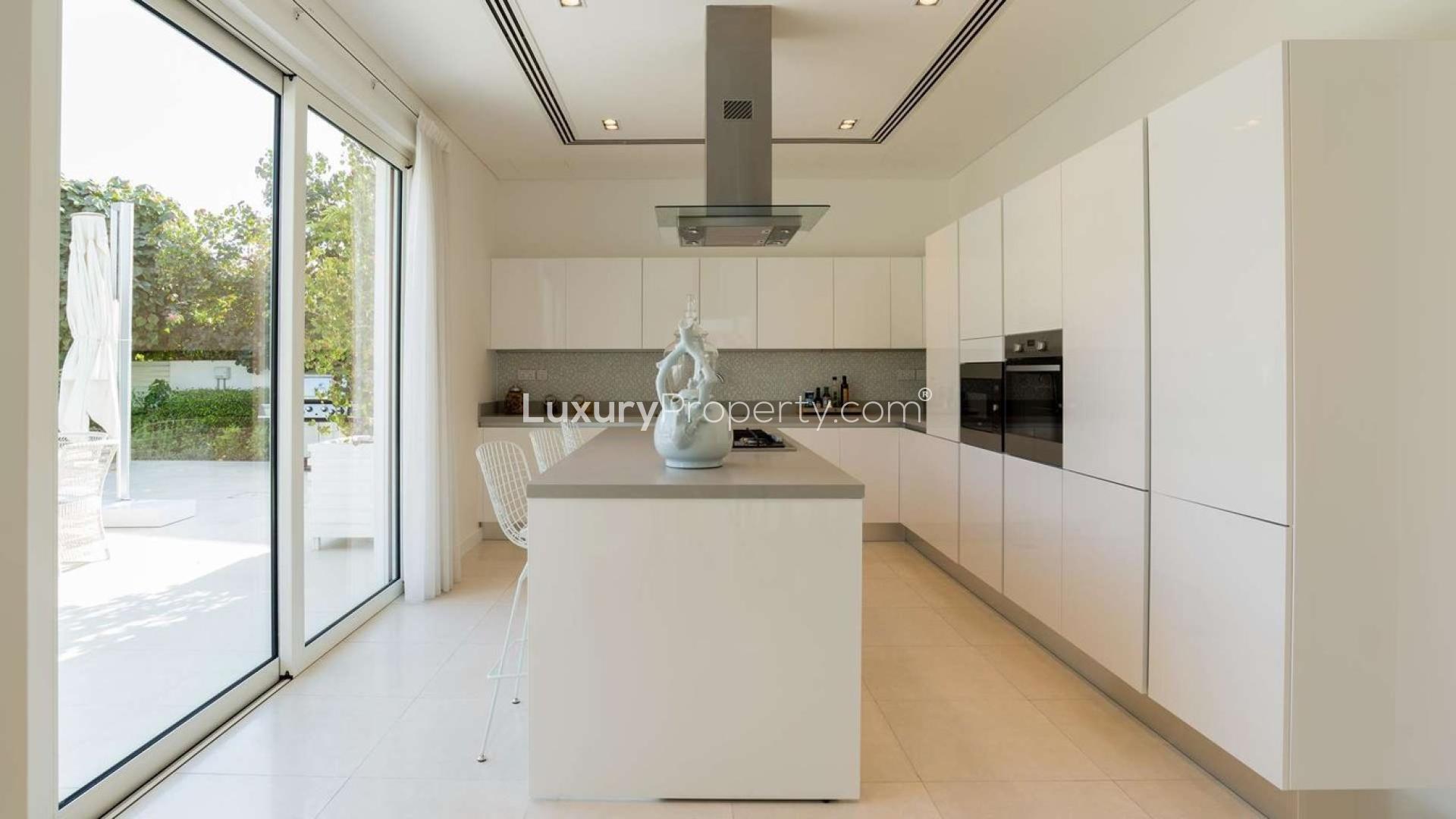 Modern living room in Al Barari villa with elegant decor and garden views