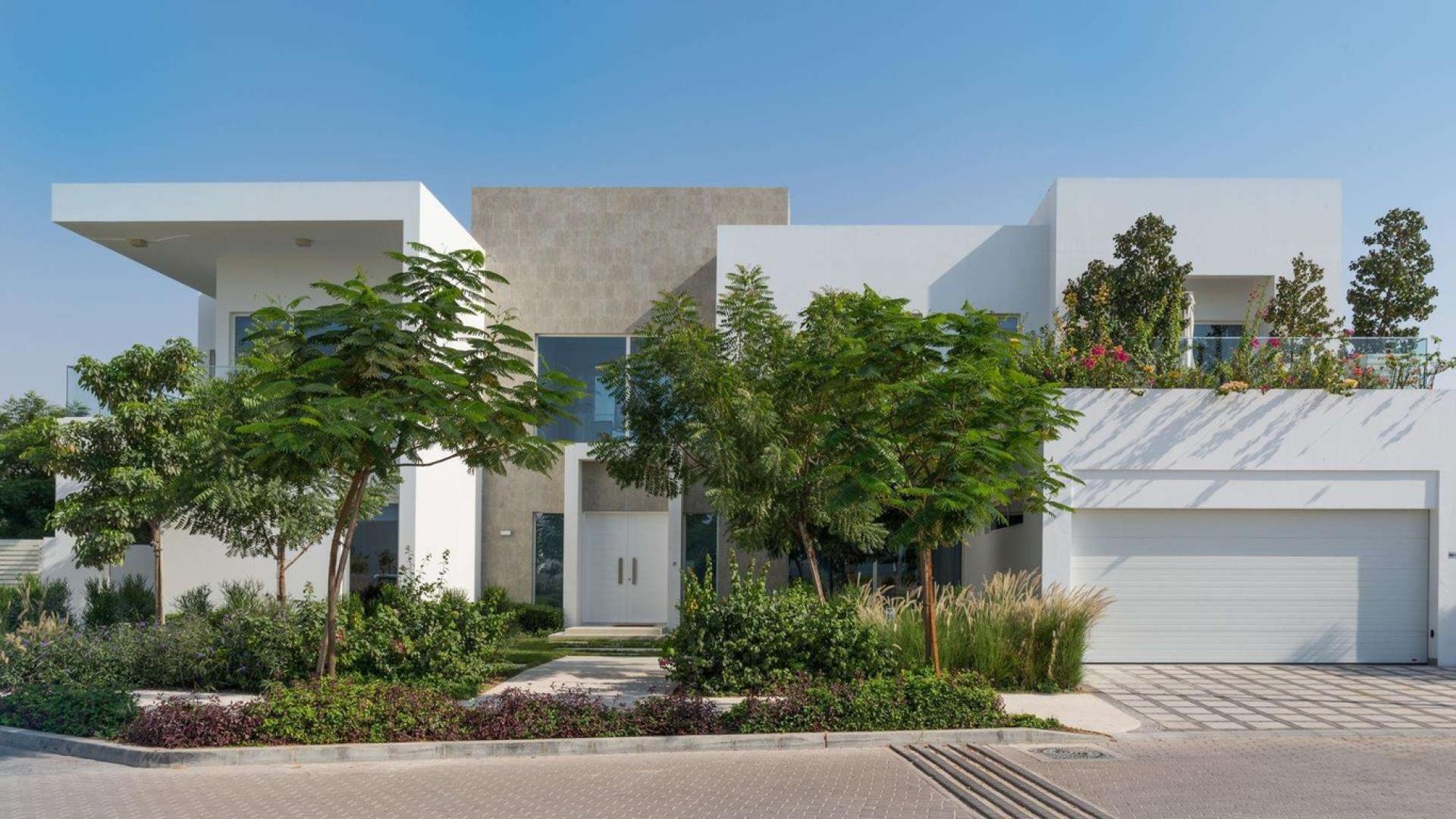 Modern four-bedroom villa exterior at The Nest, Al Barari, surrounded by lush greenery