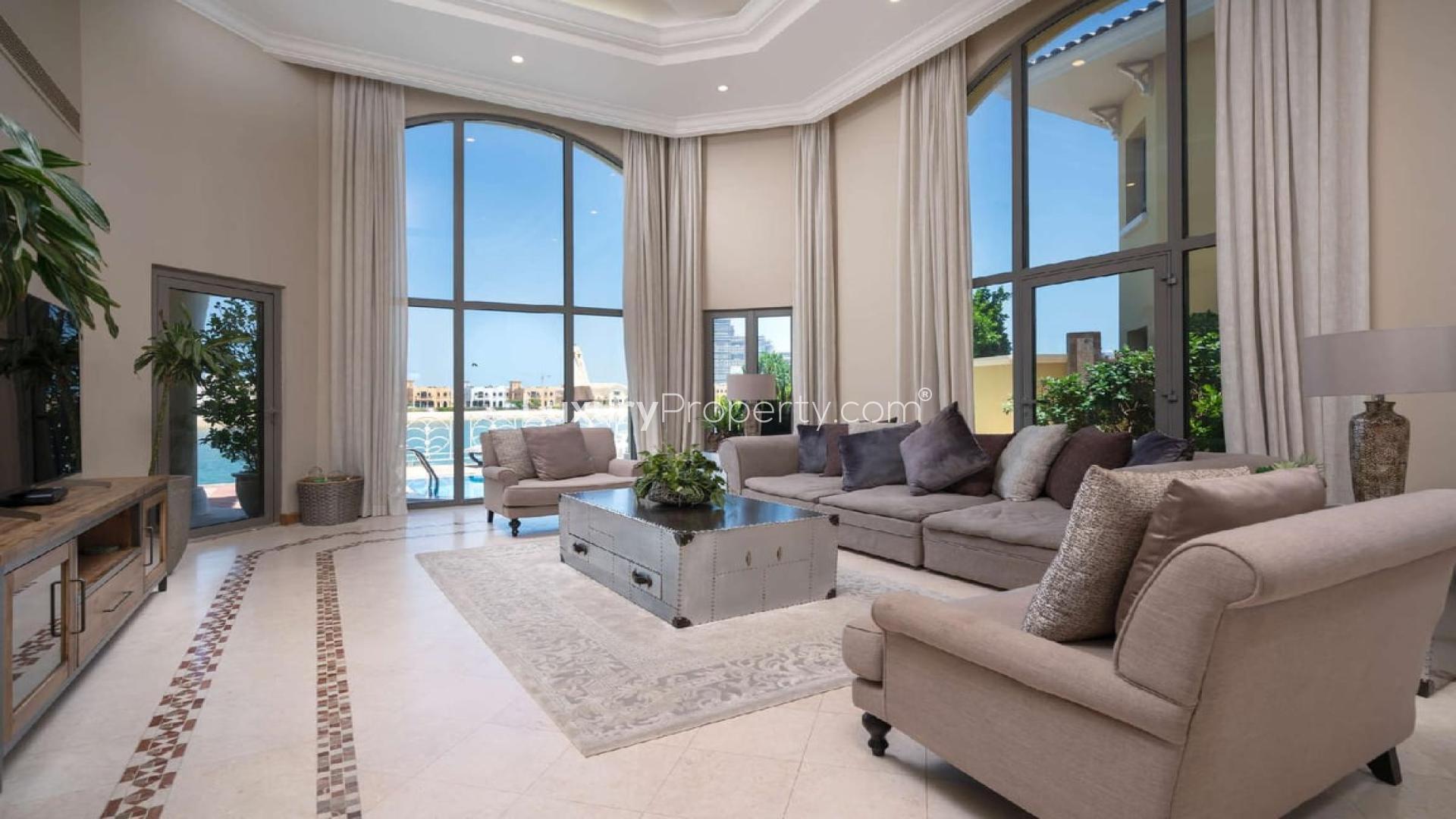 Luxurious living room in four-bedroom villa, Palm Jumeirah, with large windows and elegant decor
