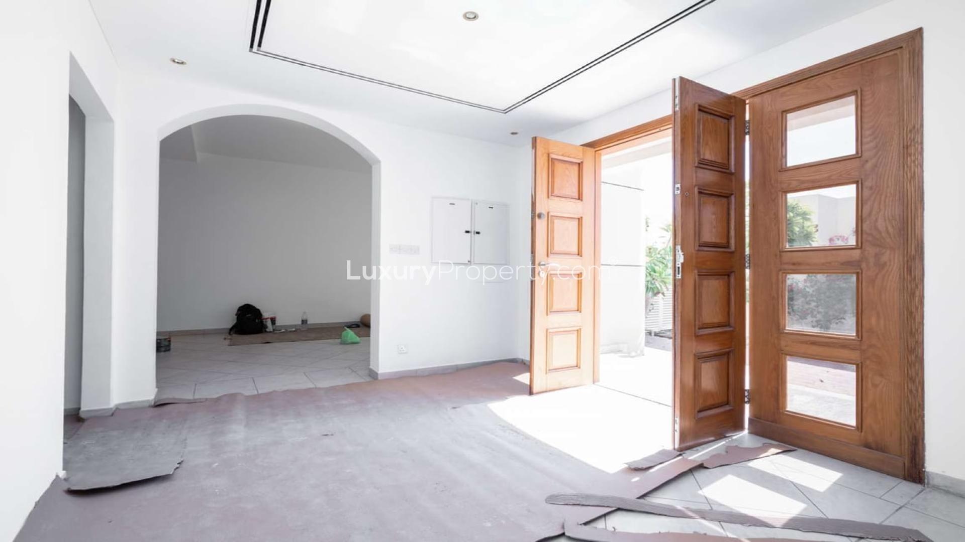 Open entrance with wooden doors in Al Wasl villa, Jumeirah 1, available for rent