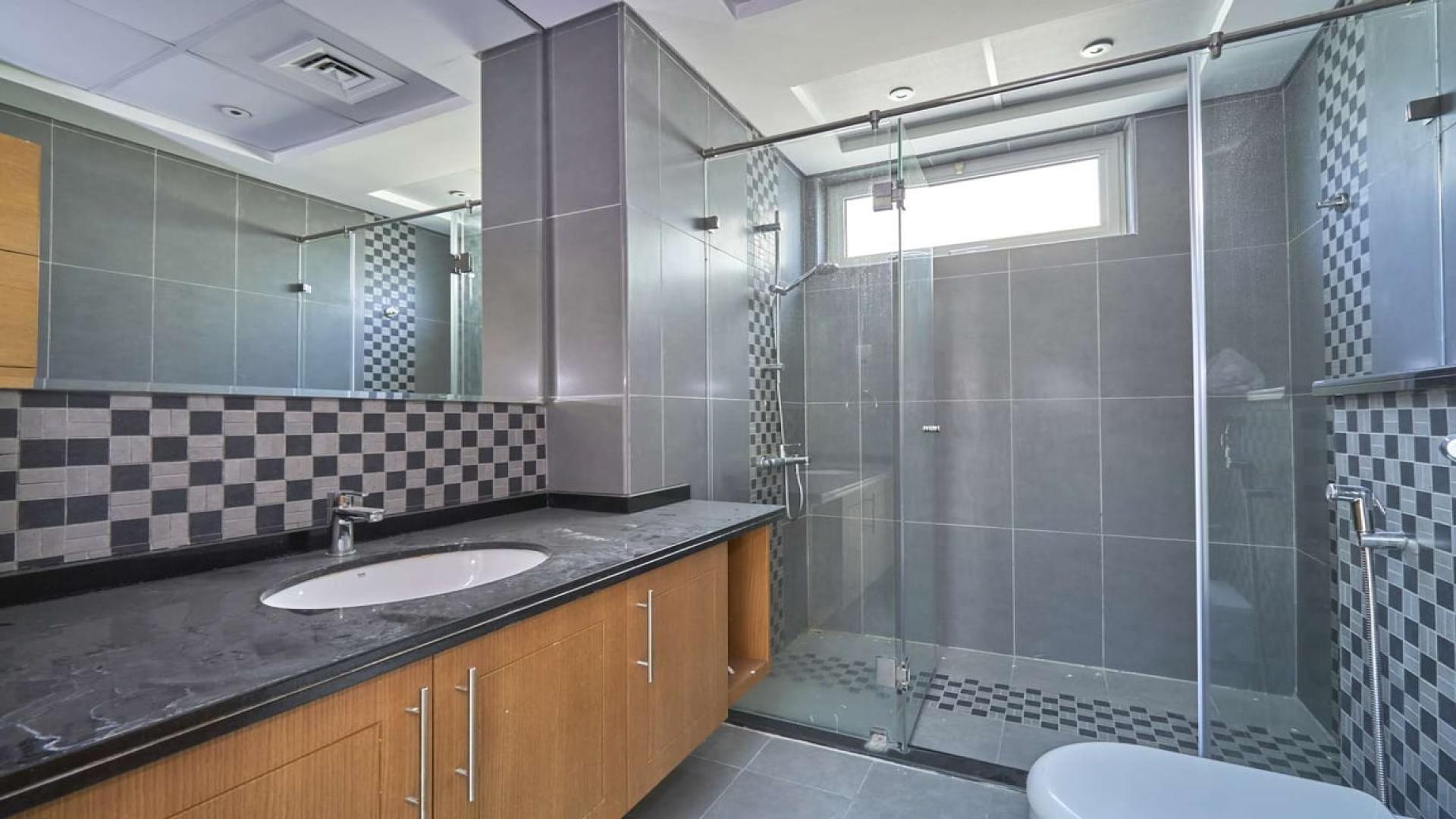 Open-plan living area in Jumeirah Park villa with natural light and garden view