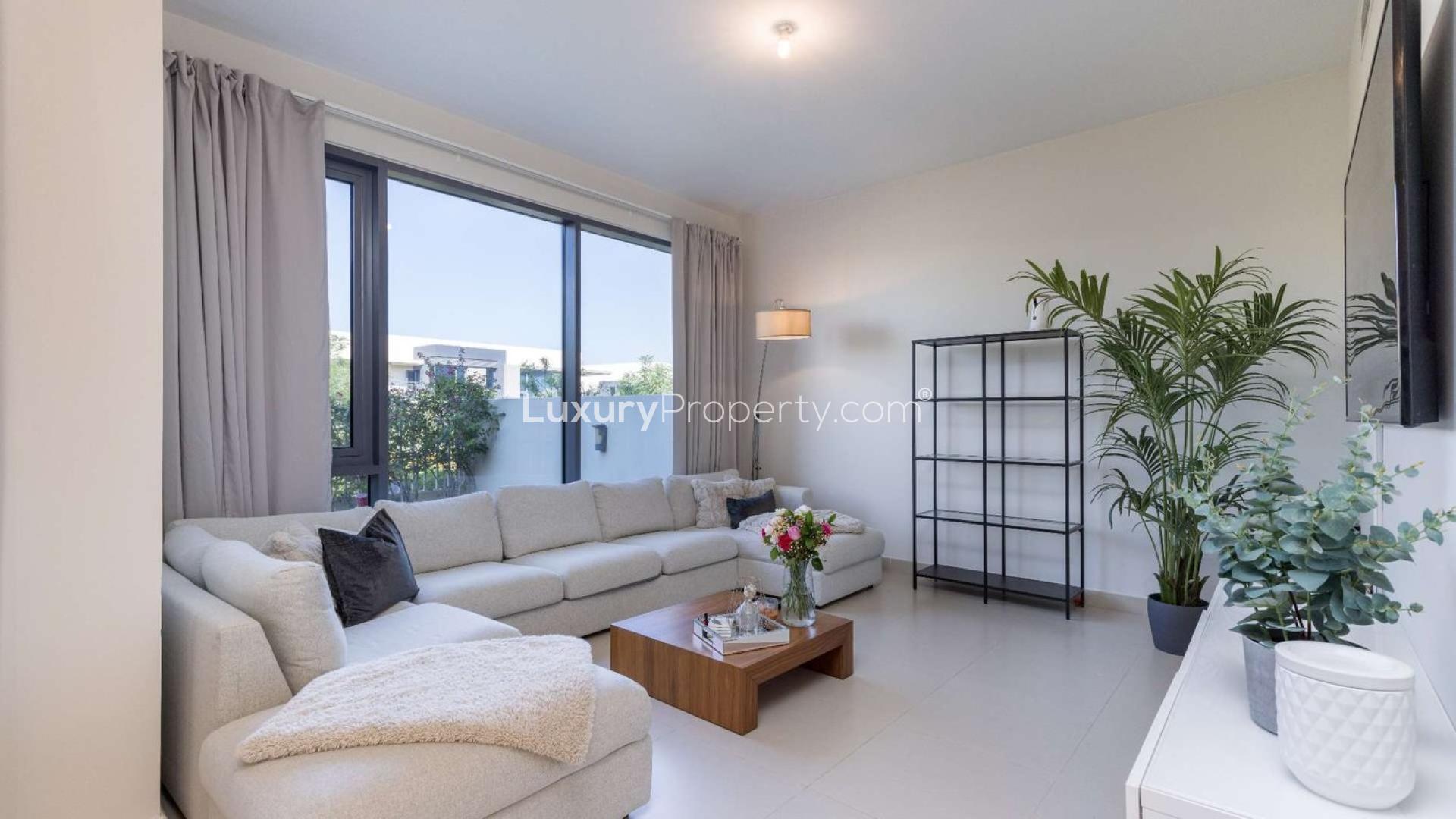 Modern living room in 4-bedroom townhouse, Maple, Dubai Hills Estate, with garden view