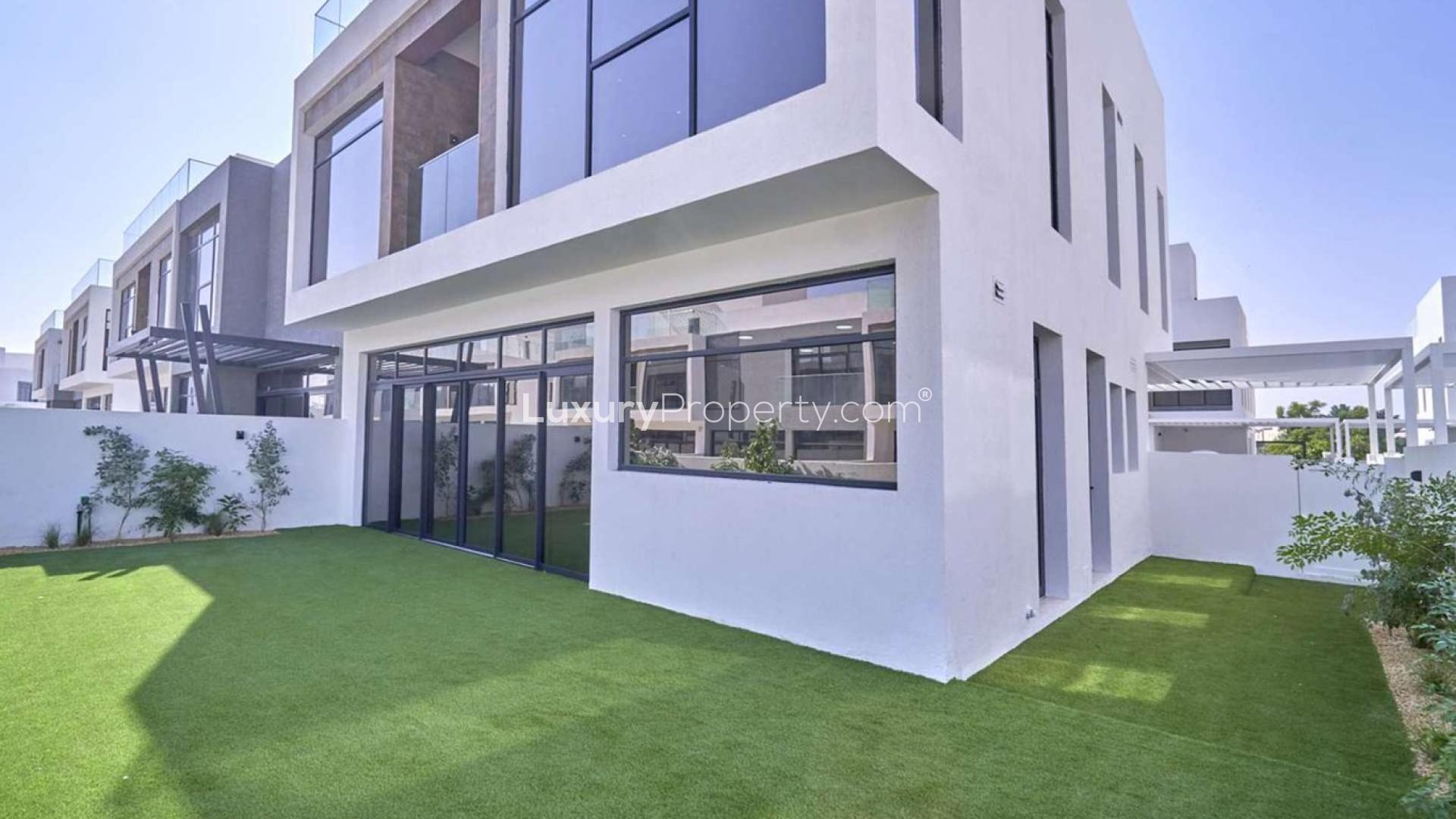 Contemporary 4-bedroom villa exterior with lush lawn at Jumeirah Golf Estates, Dubai