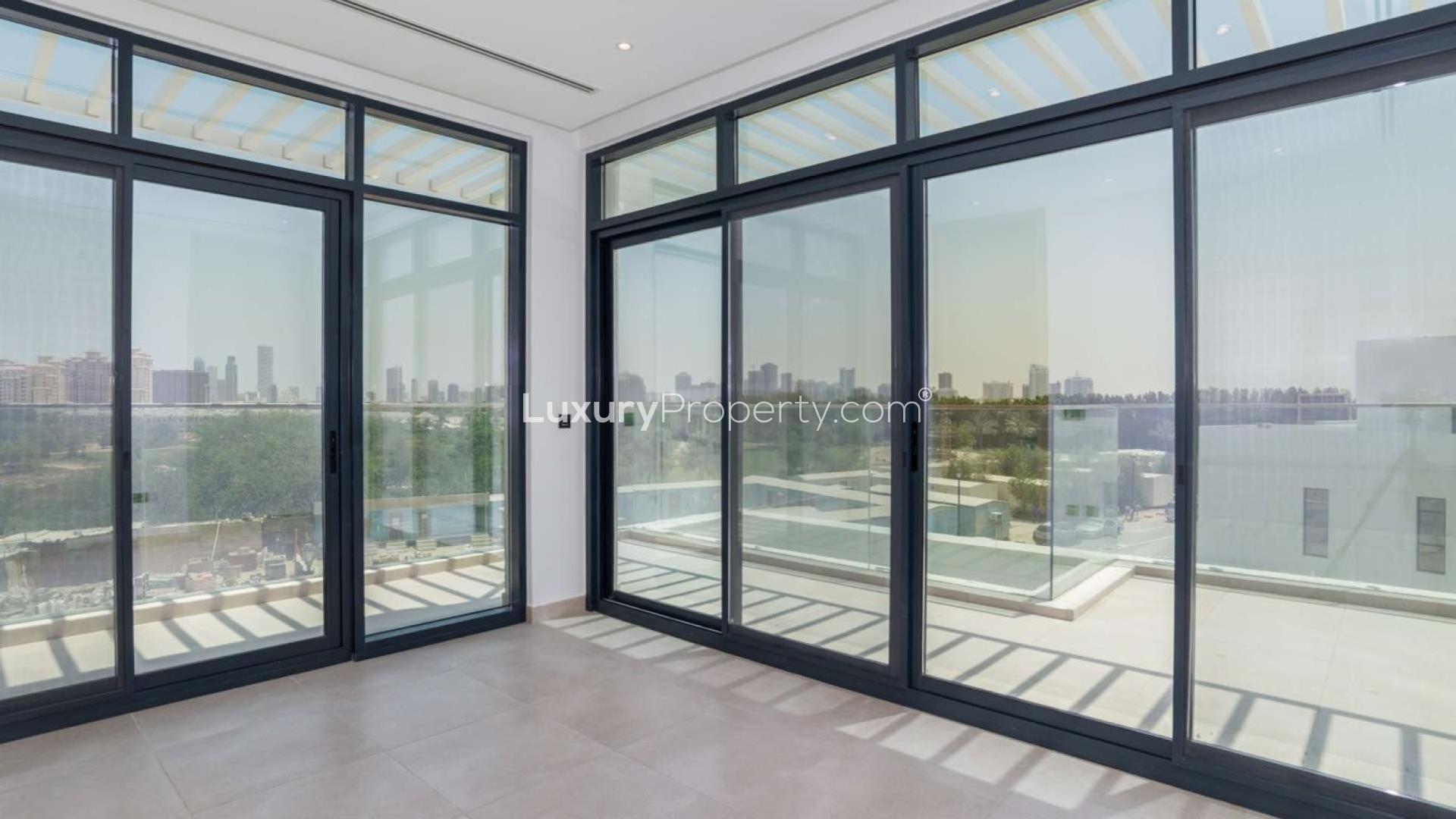 N/A,Modern villa interior with large windows, open view of landscaped garden in Jumeirah Golf Estates