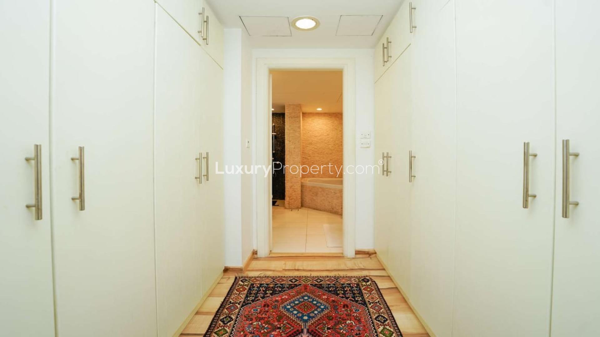 Entrance of fully upgraded villa in Meadows 6 with wooden floors and blue door