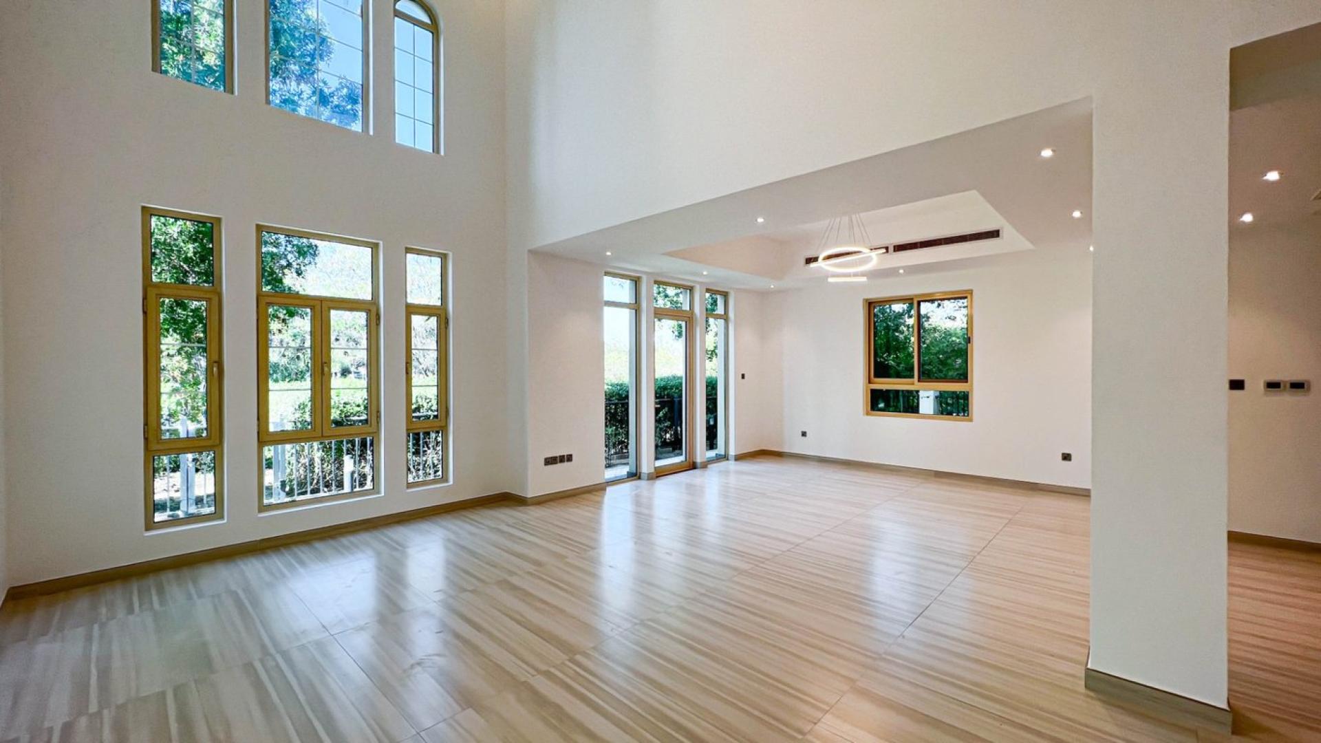 Spacious living room in upgraded Jumeirah Islands villa with large windows and modern lighting