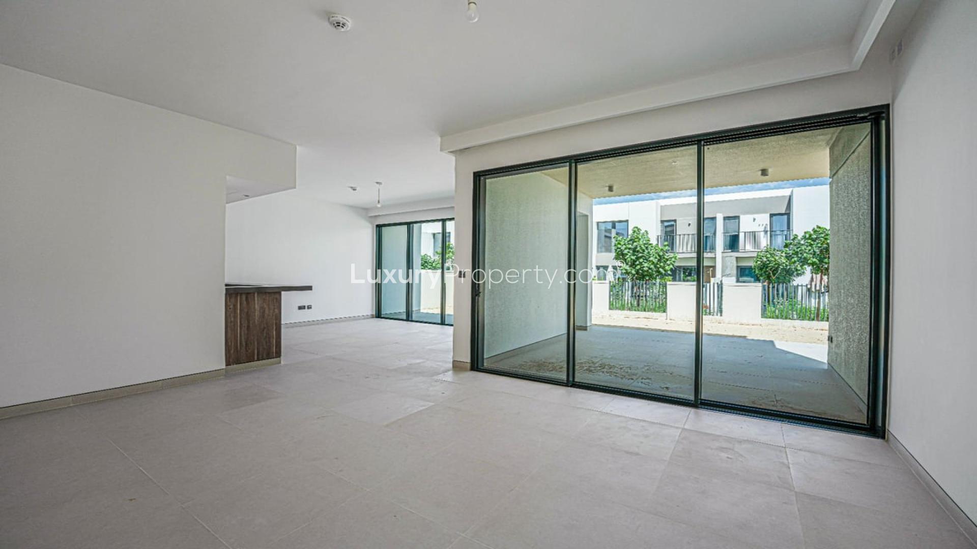 Spacious living room with large glass doors in Harmony Villa, Tilal Al Ghaf for rent