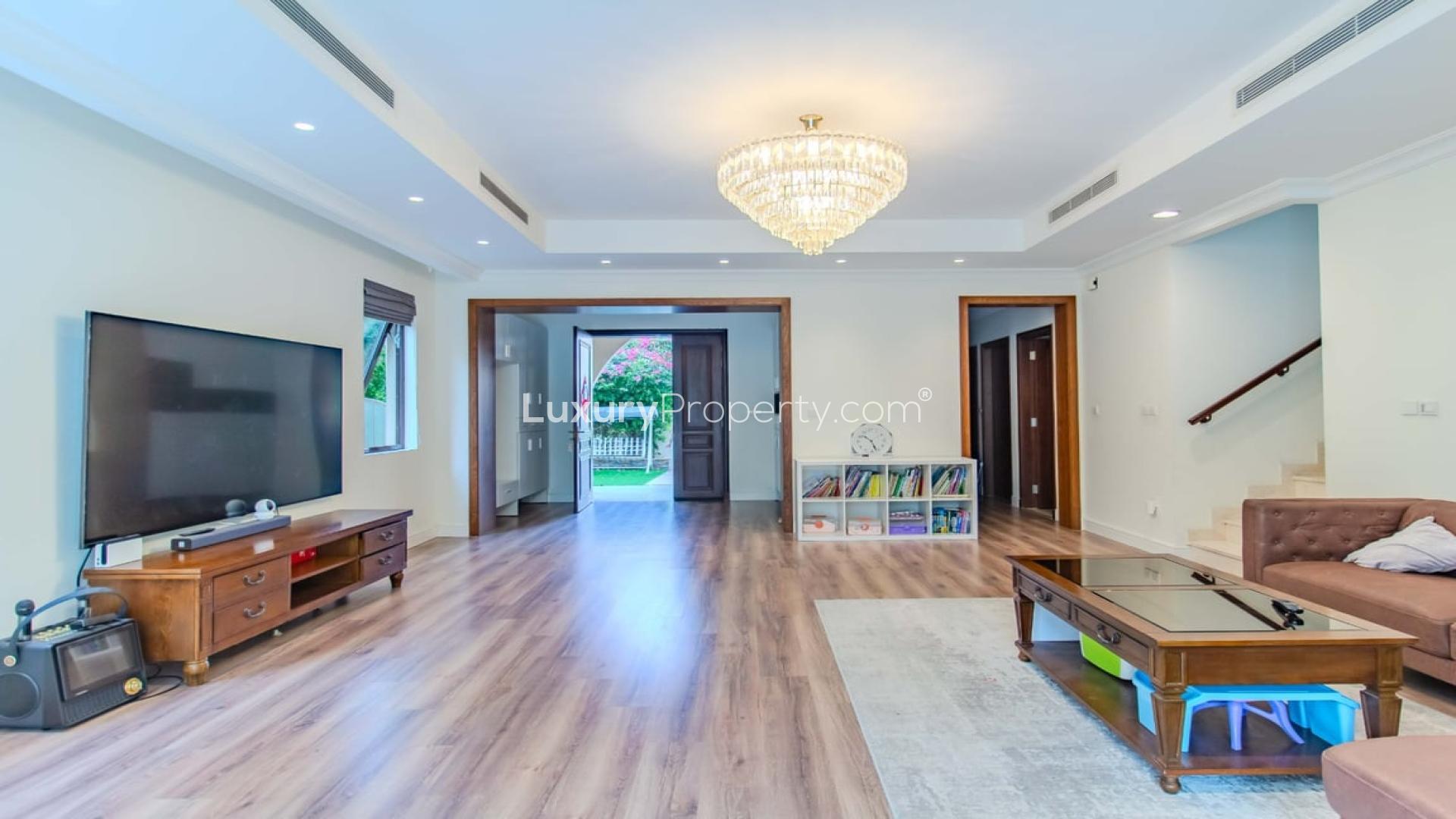 Spacious living room in 4-bedroom villa, Palma Arabian Ranches 2, with modern decor and garden view