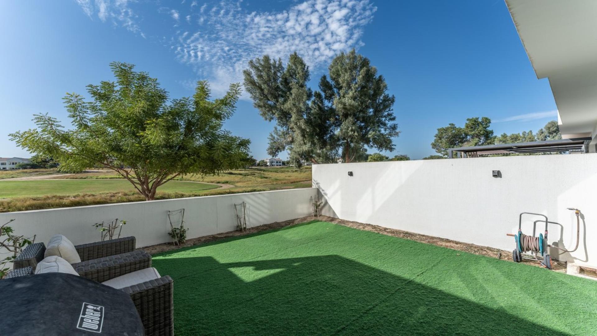 Contemporary villa living room with large windows, modern furniture, near Earth Golf Course