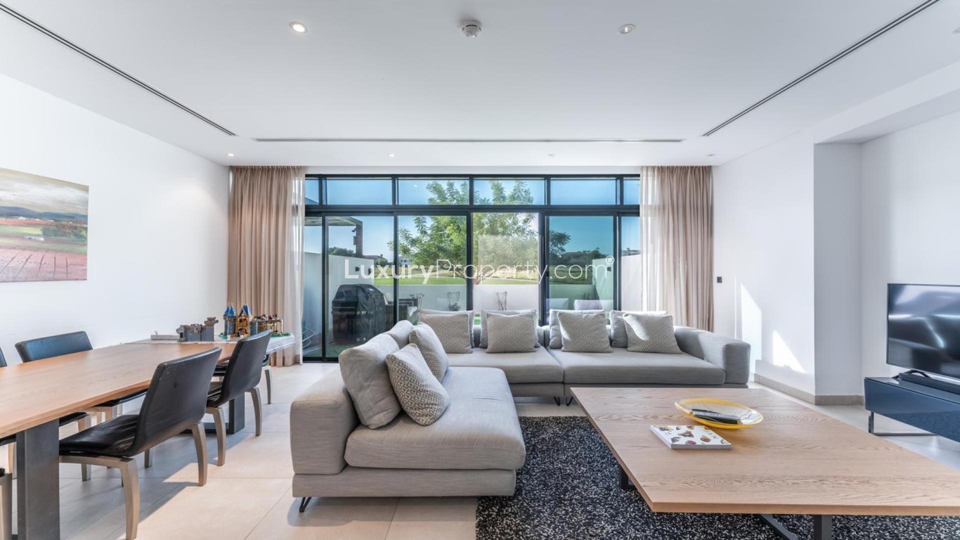 Contemporary villa living room with large windows, modern furniture in Jumeirah Golf Estates
