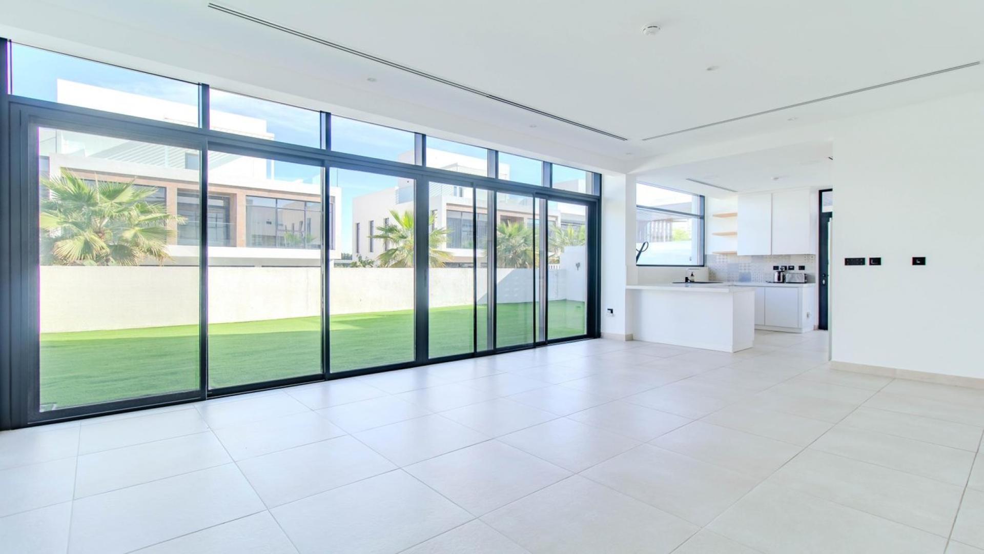 Modern 4-bed villa exterior in Jumeirah Golf Estates, featuring carport and contemporary design