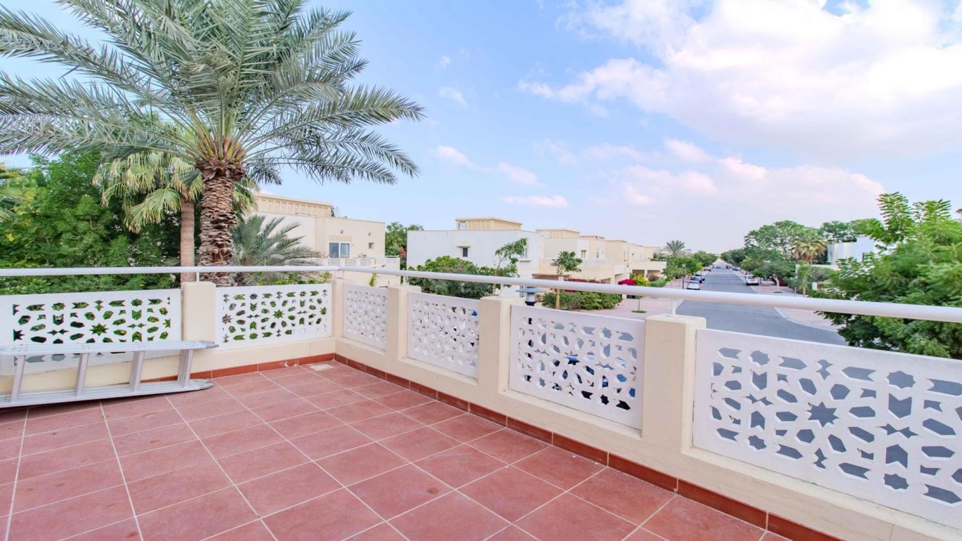 Terrace view of Meadows 9 villa with palm trees and landscaped surroundings.