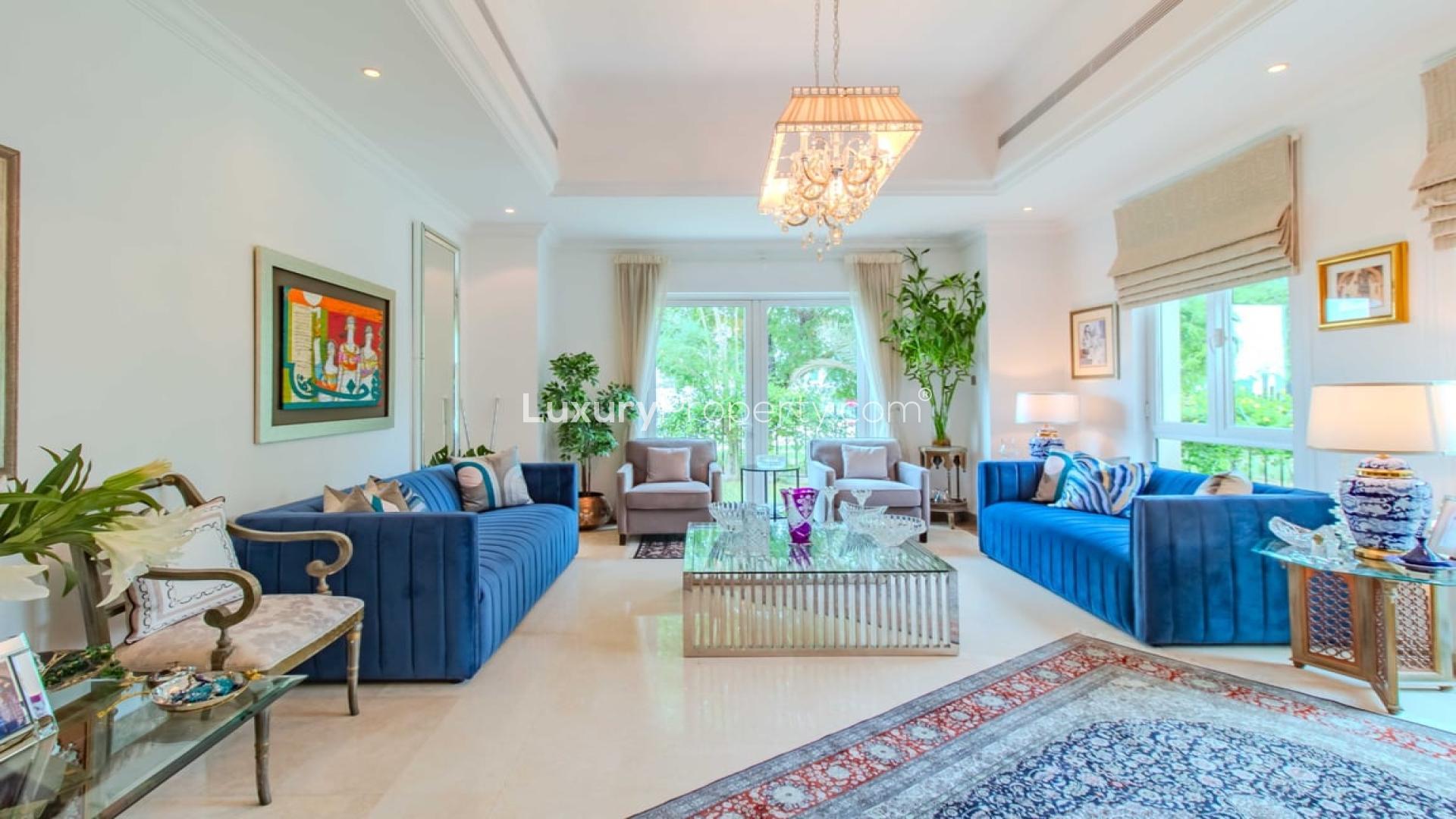 Elegant entrance of renovated villa in Jumeirah Islands with chandelier and wooden doors