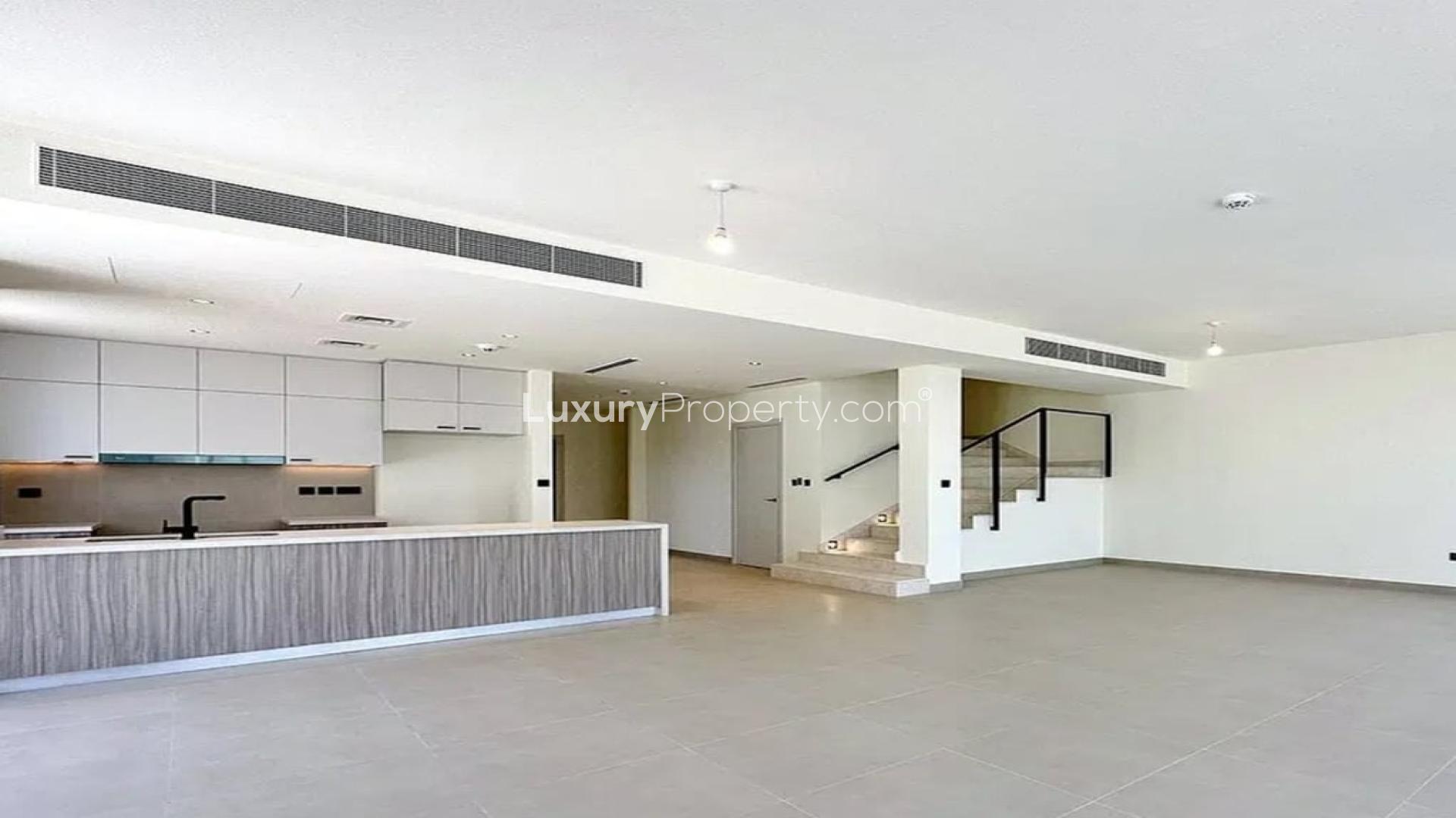 Spacious open-plan living area with modern kitchen in Dubai Hills Estate villa for rent
