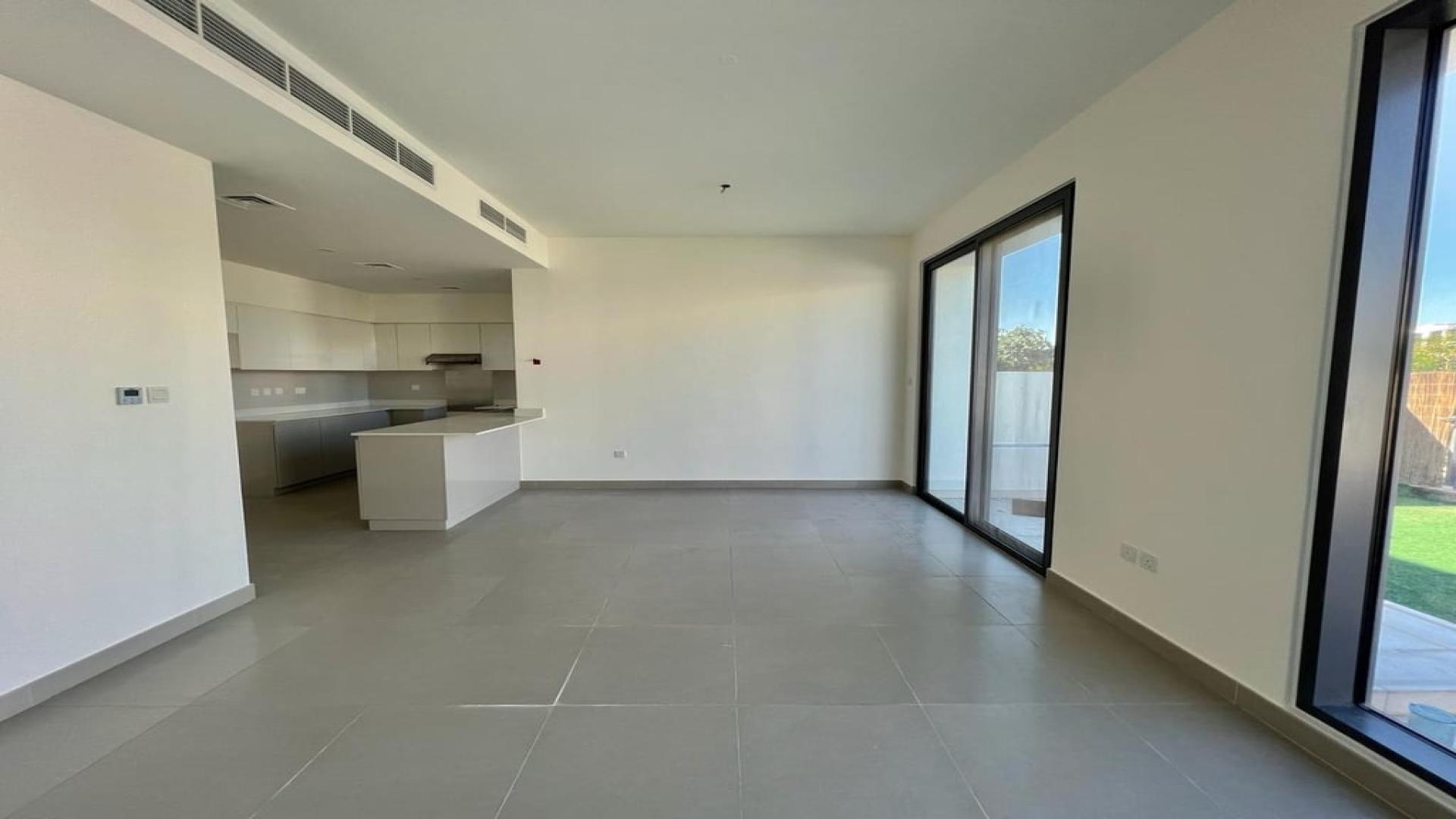 Spacious living area with large windows in Dubai Hills Estate villa for rent
