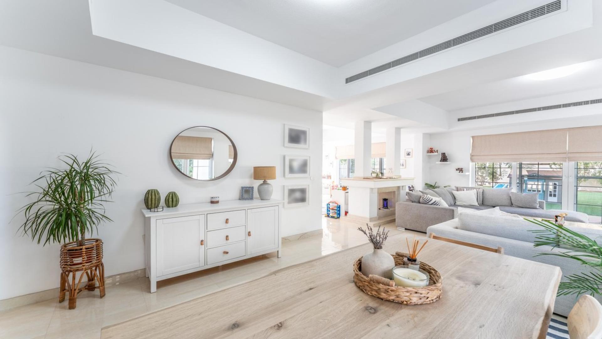 Spacious living room in 4-bed villa, Mirador, Arabian Ranches, with modern decor and garden view