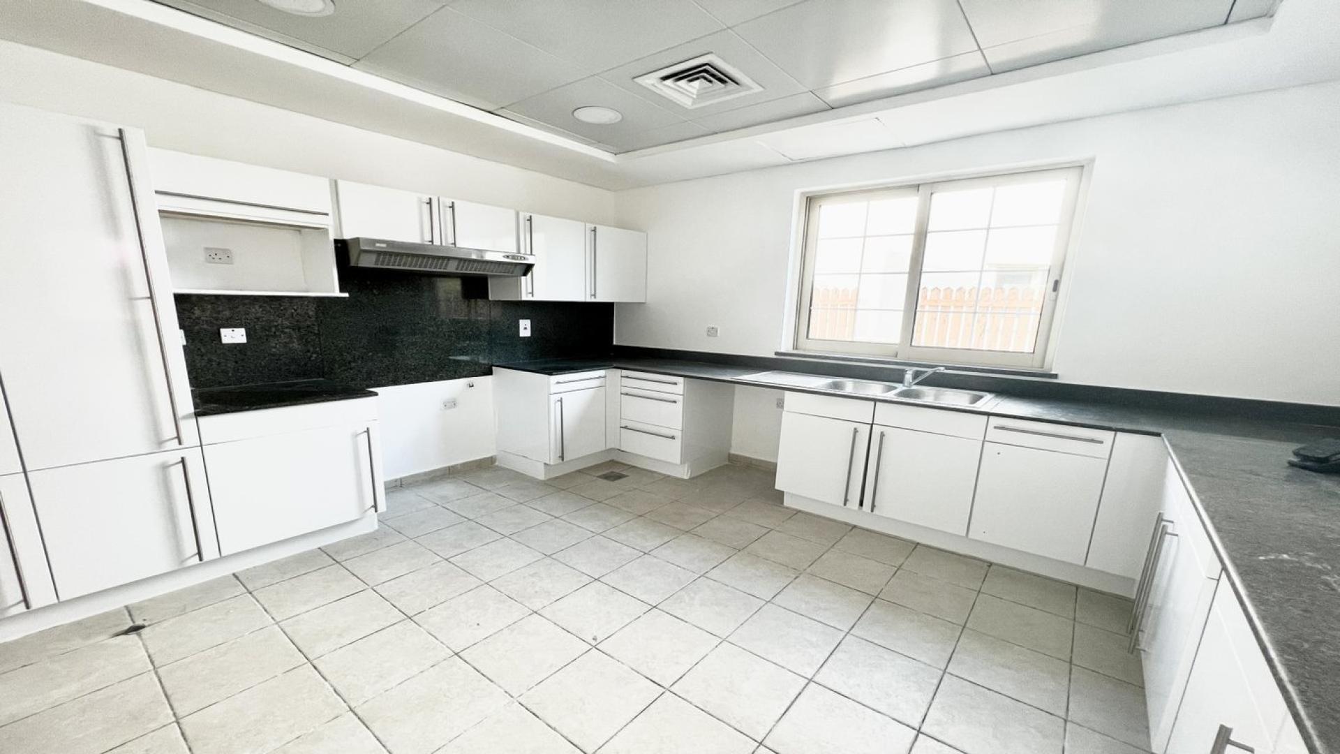 Modern kitchen in Jumeirah Islands villa, featuring sleek countertops and ample natural light