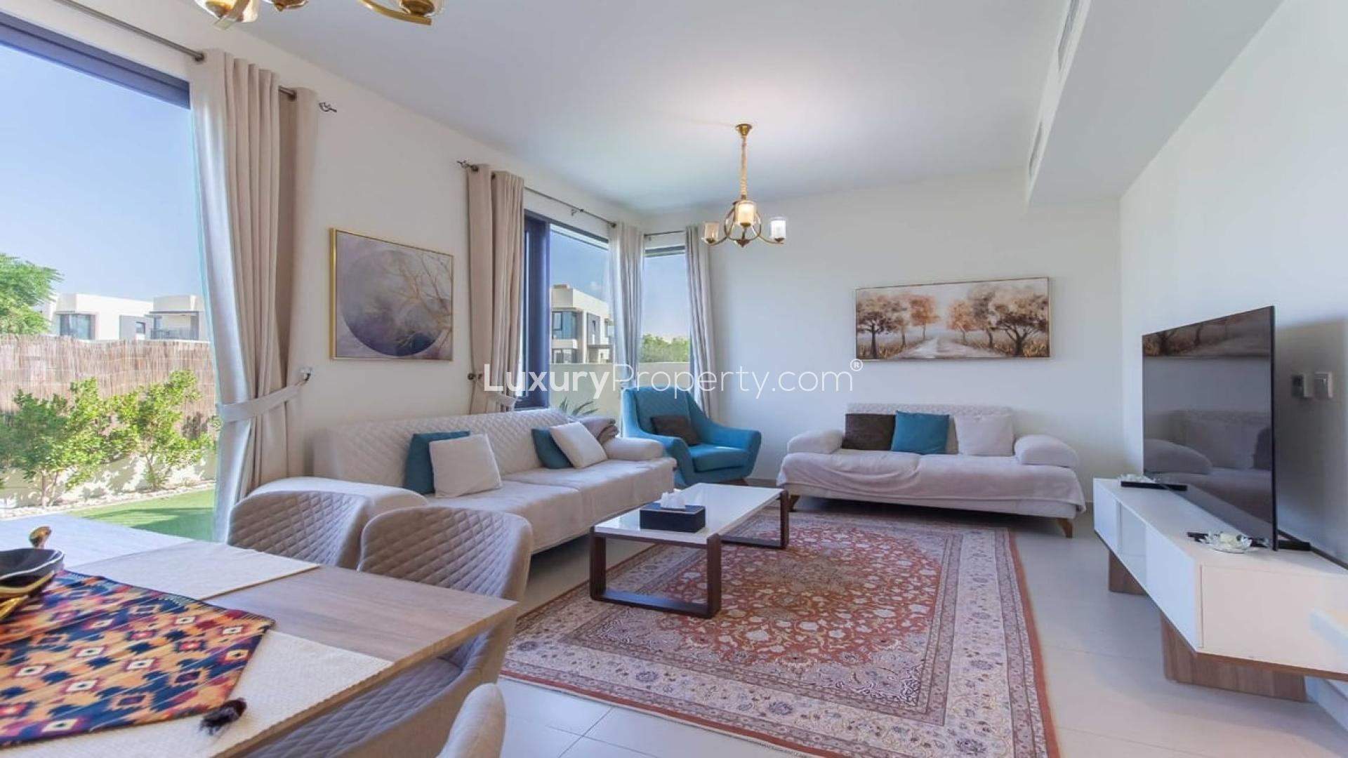 "Spacious garden view of corner villa in Maple, Dubai Hills Estate, available for rent.",Furnished living room in corner villa, Maple at Dubai Hills Estate, available for rent