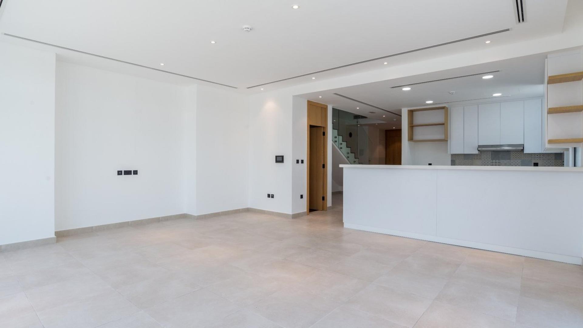 Modern villa interior with large glass doors opening to landscaped garden in Jumeirah Luxury