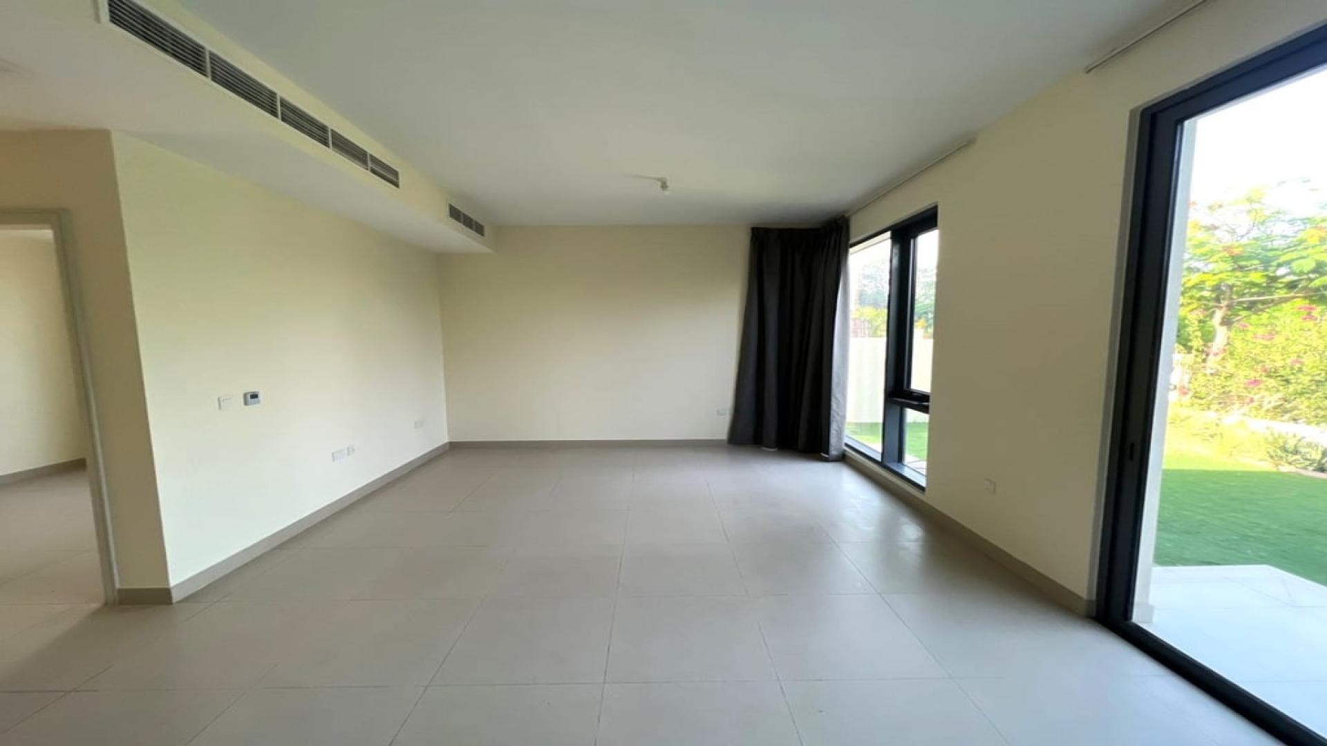 Spacious living area in four-bed villa, Maple at Dubai Hills Estate, open kitchen view