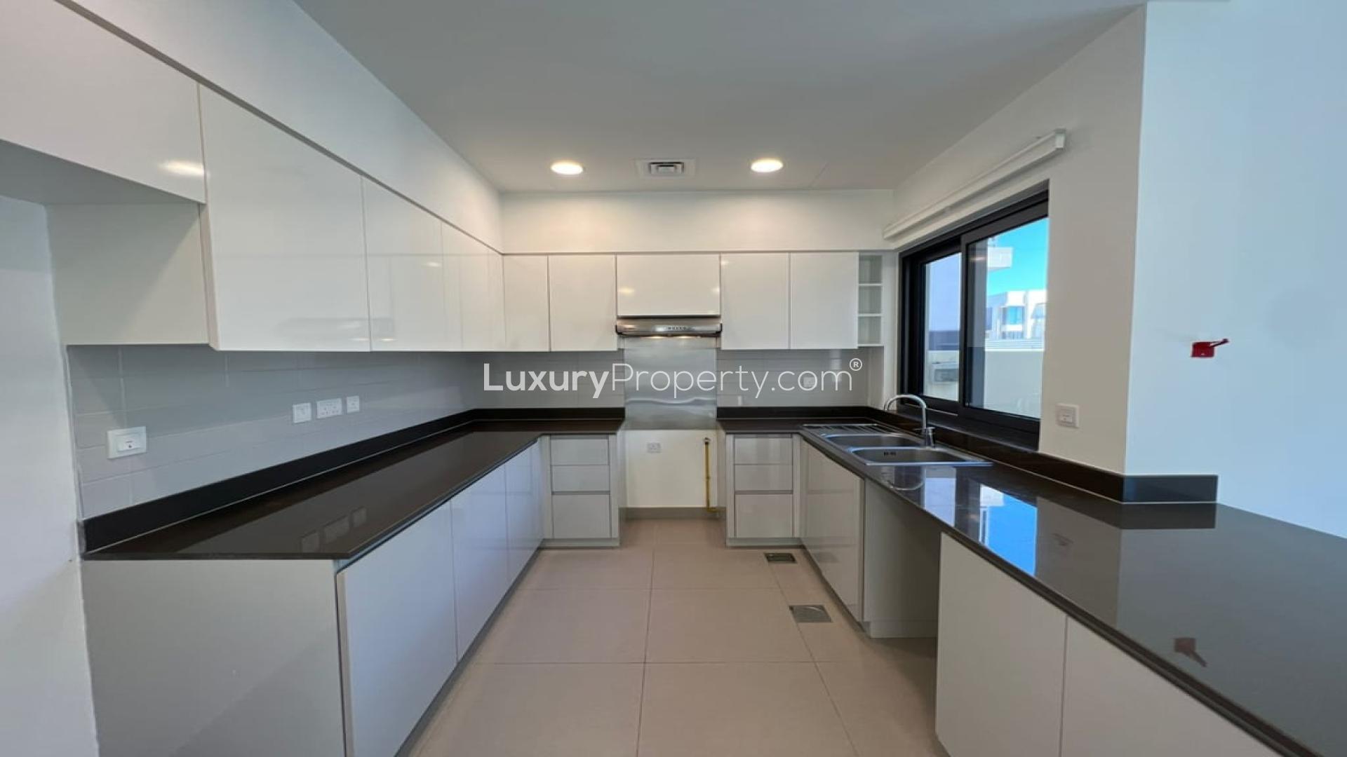 "Spacious kitchen and living area in 4-bedroom villa, Dubai Hills Estate, Maple community.",Modern kitchen in 4-bedroom villa, Maple at Dubai Hills Estate, available for rent