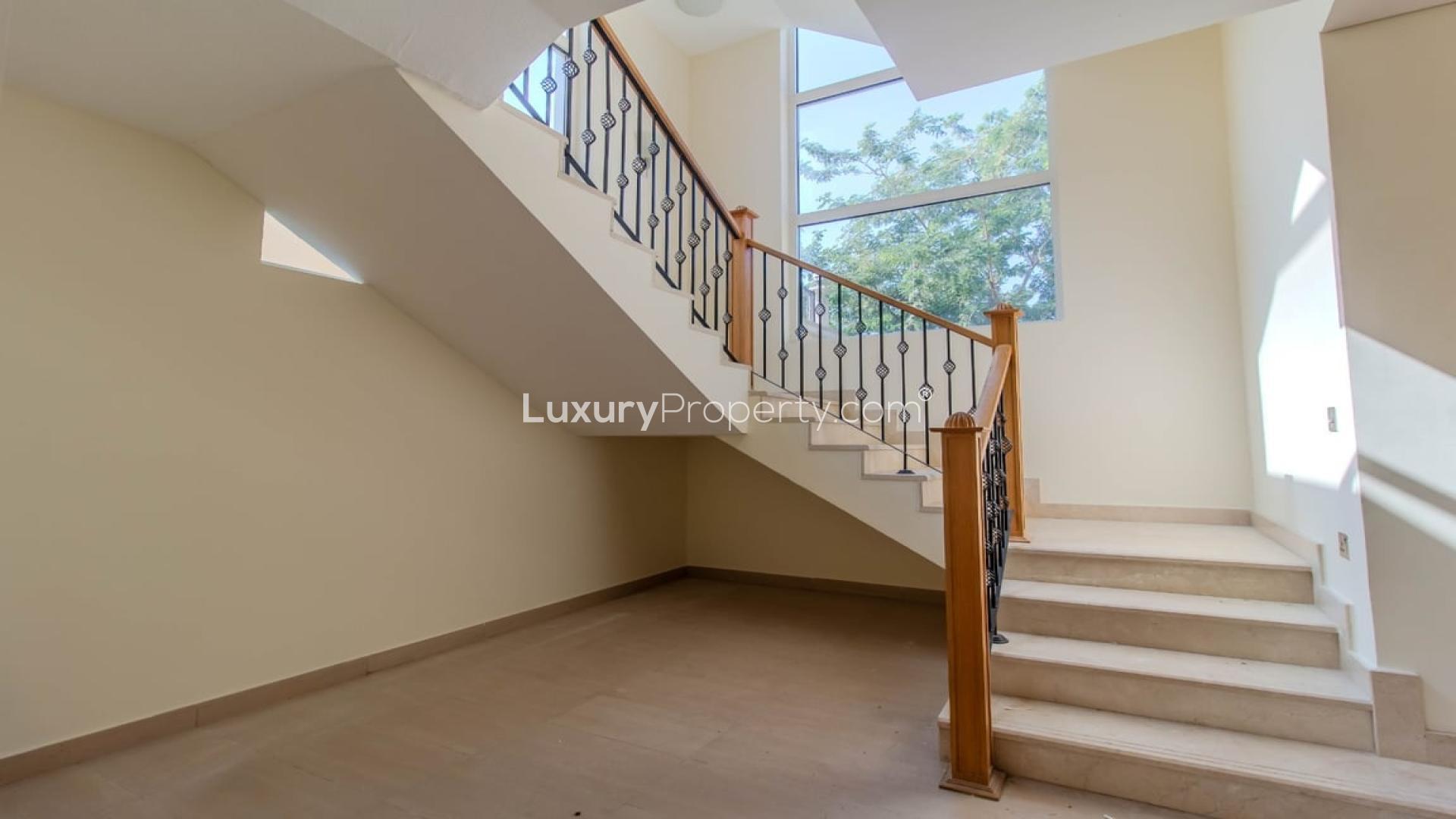 "Single-row Legacy villa exterior with large garden in Jumeirah Park, available for rent.",Staircase in bright 4-bedroom Legacy Villa, Jumeirah Park, available for rent