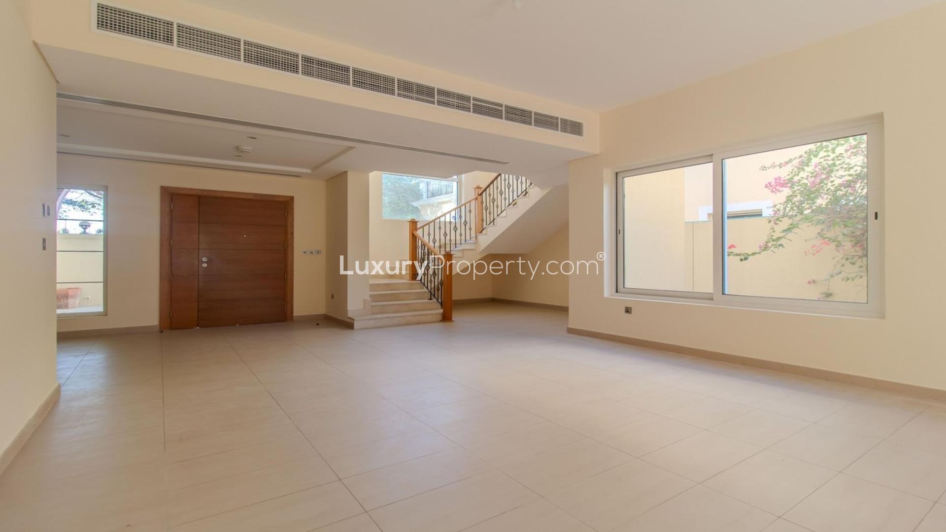 "Serene villa garden view in Jumeirah Park's Legacy Nova Villas for rent, LP41074.",Spacious living area in Jumeirah Park Legacy Nova Villa with large windows and staircase