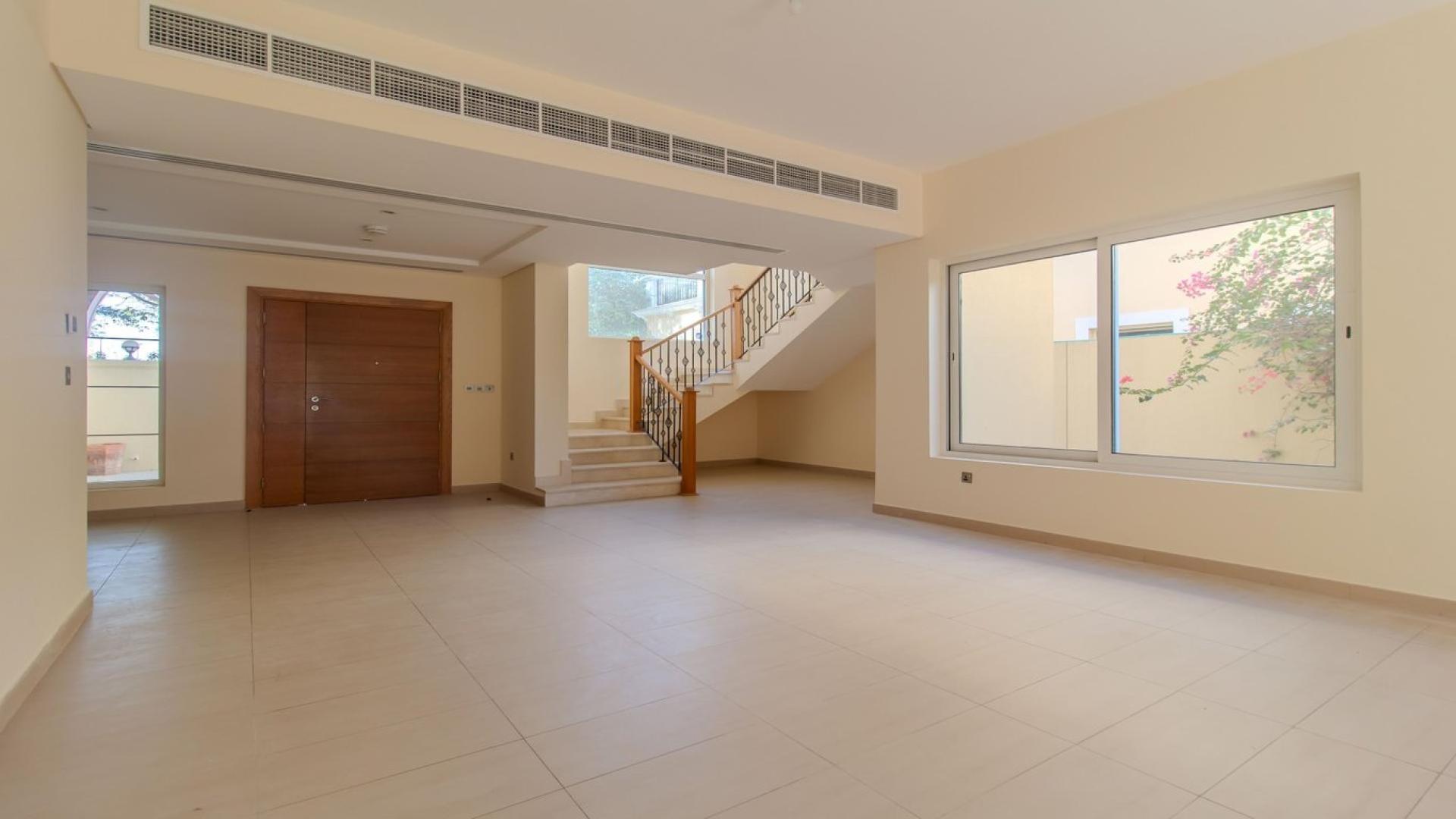 "Serene villa garden view in Jumeirah Park's Legacy Nova Villas for rent, LP41074.",Spacious living area in Jumeirah Park Legacy Nova Villa with large windows and staircase