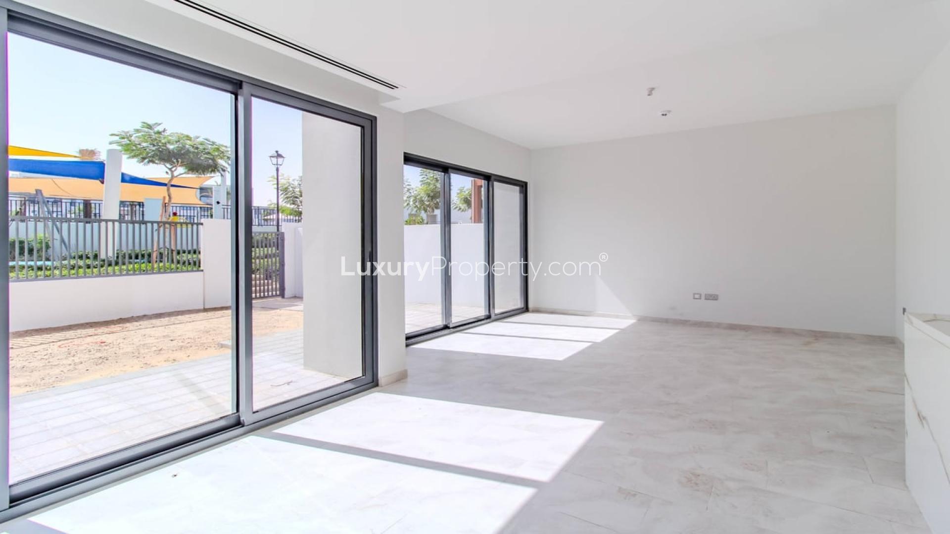 Dubai Land Villanova villa view with playground, greenery, and community landscape