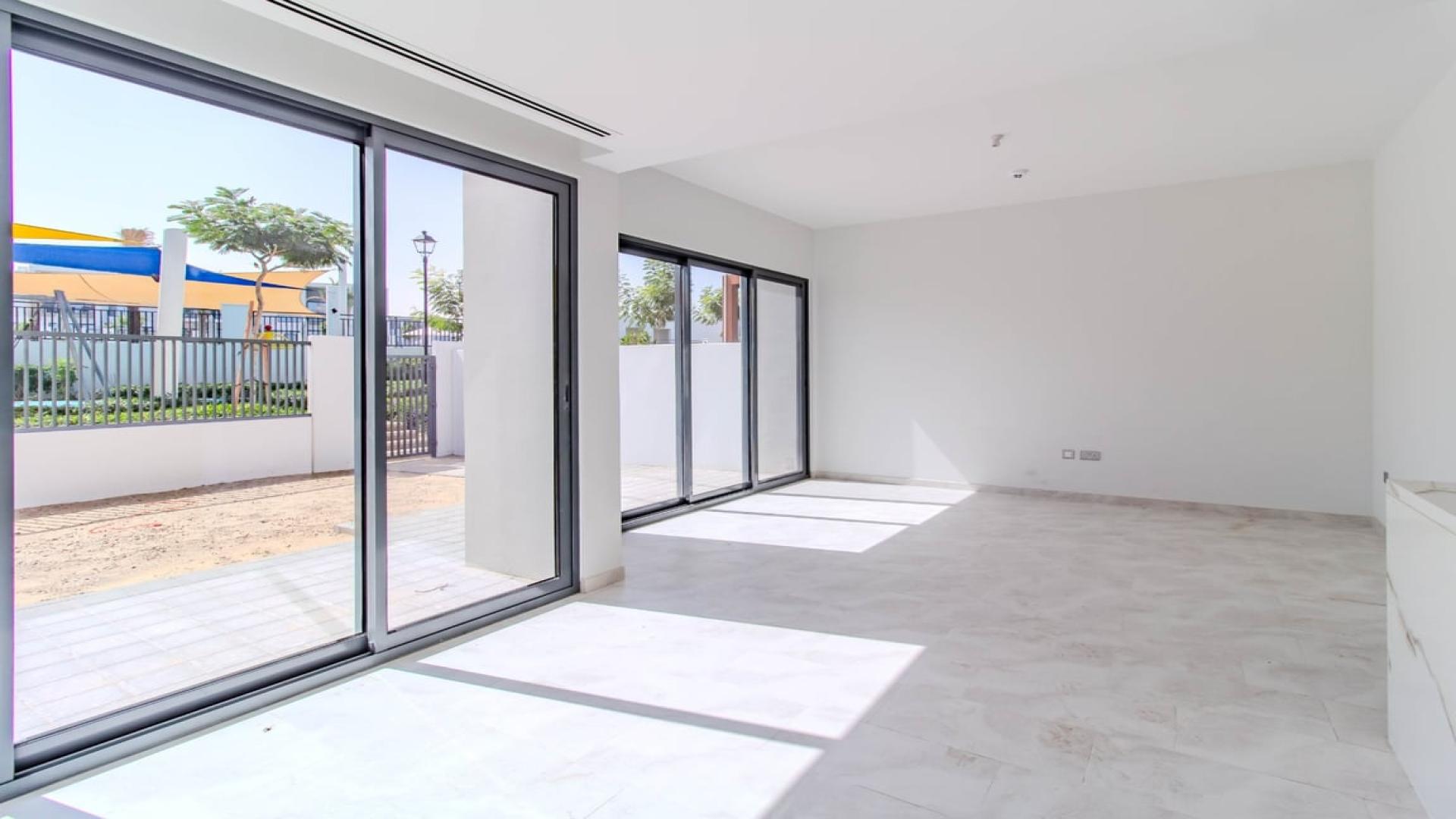 Dubai Land Villanova villa view with playground, greenery, and community landscape