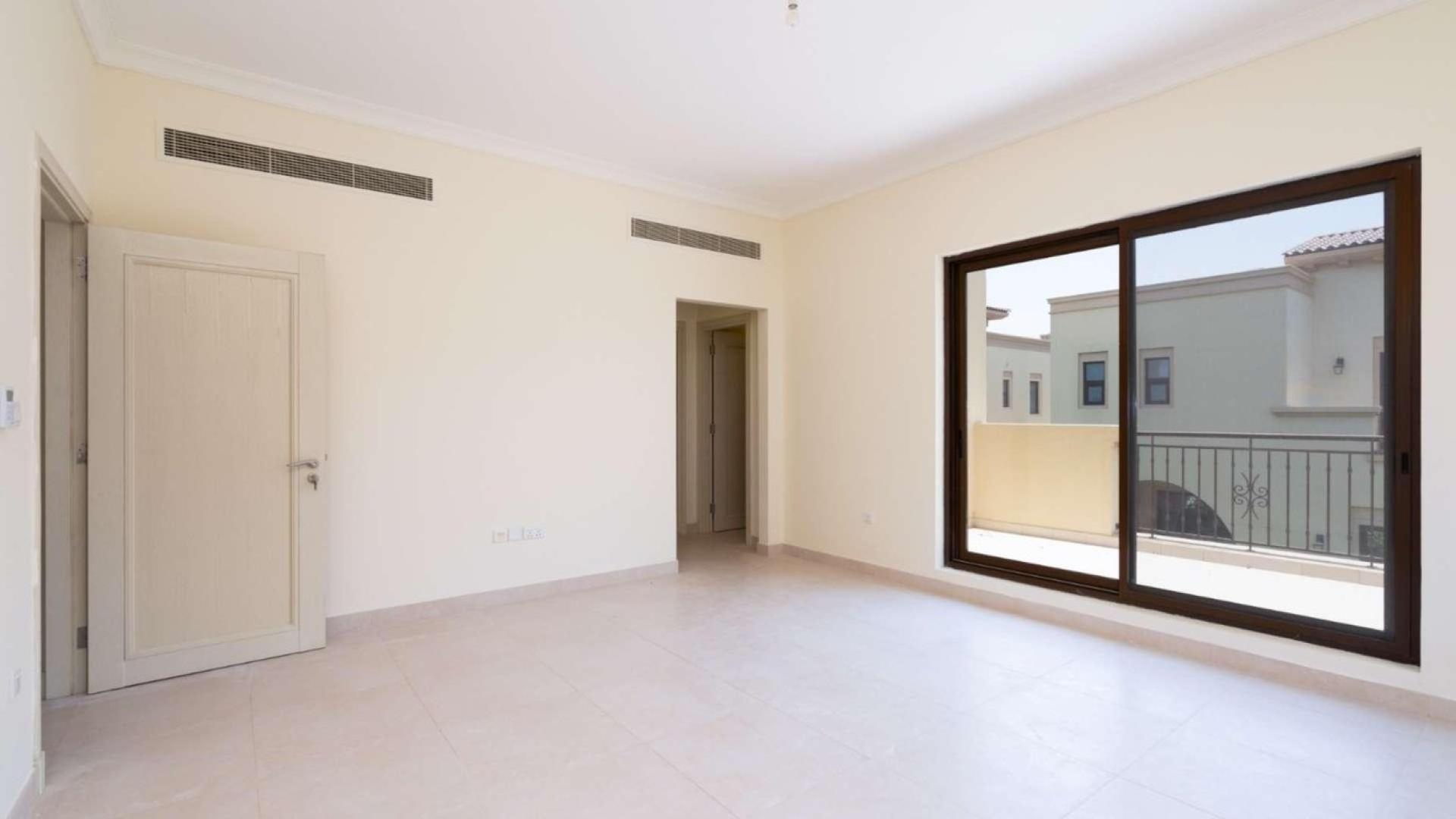 "Spacious kitchen and living area in Palma villa, Arabian Ranches 2, for rent.",Bright bedroom with large window and balcony view in Palma, Arabian Ranches 2 villa