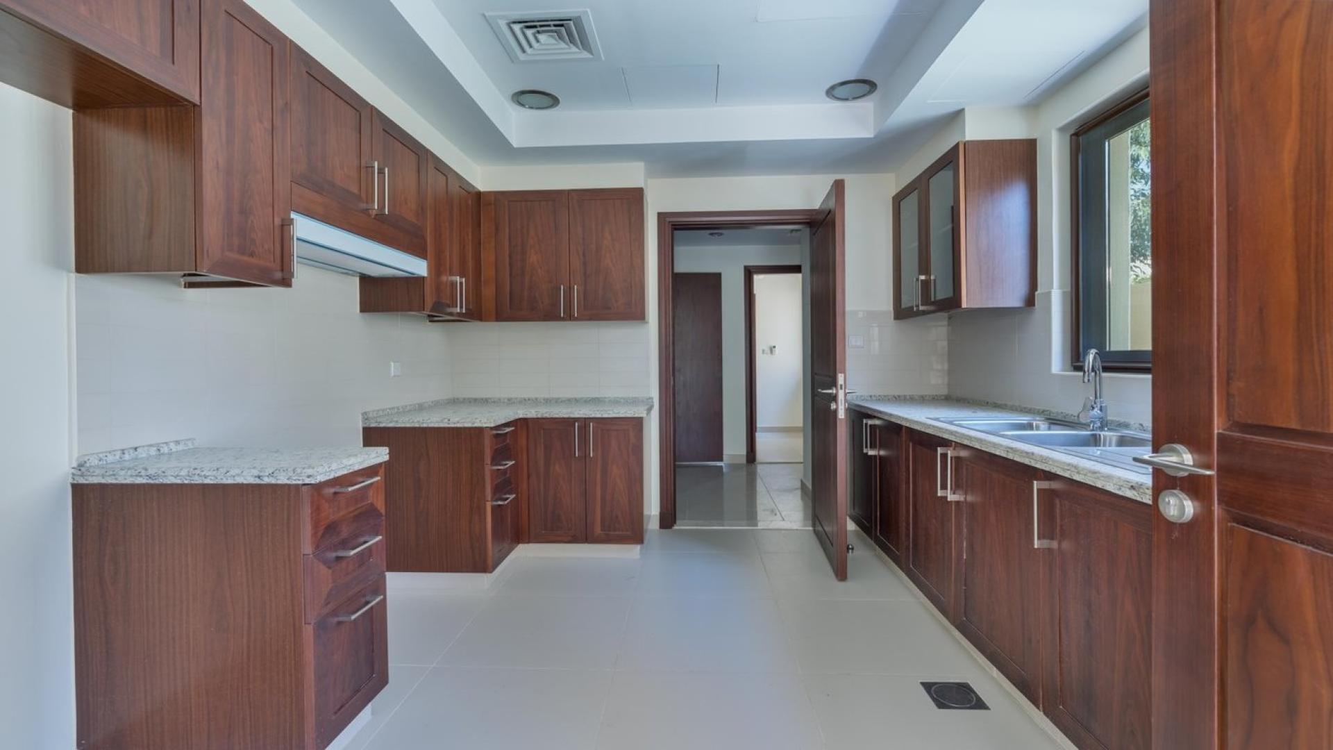 Modern kitchen with wooden cabinets in 4-bed villa, Arabian Ranches 2, Samara