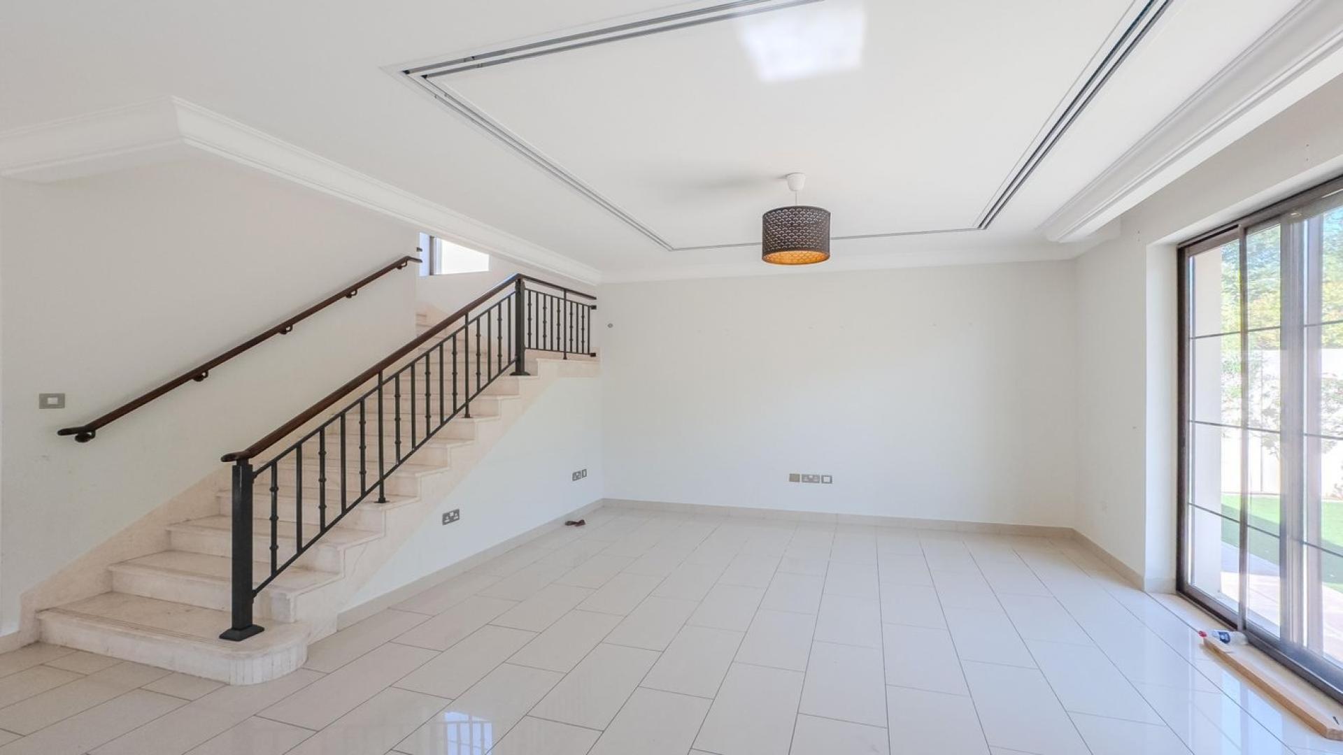 Bright living room with stairs and garden view in Arabian Ranches 2 villa