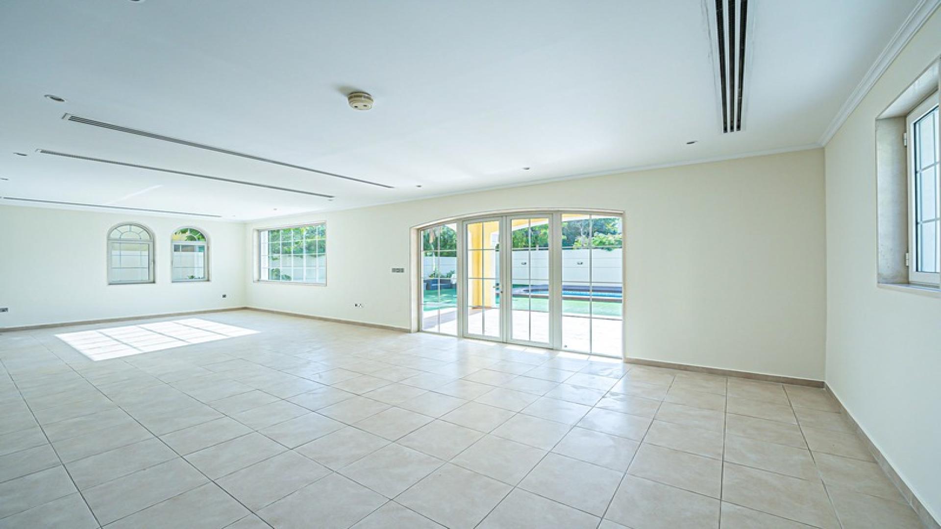 Spacious living area in Jumeirah Park villa for rent, featuring large windows and tiled floors