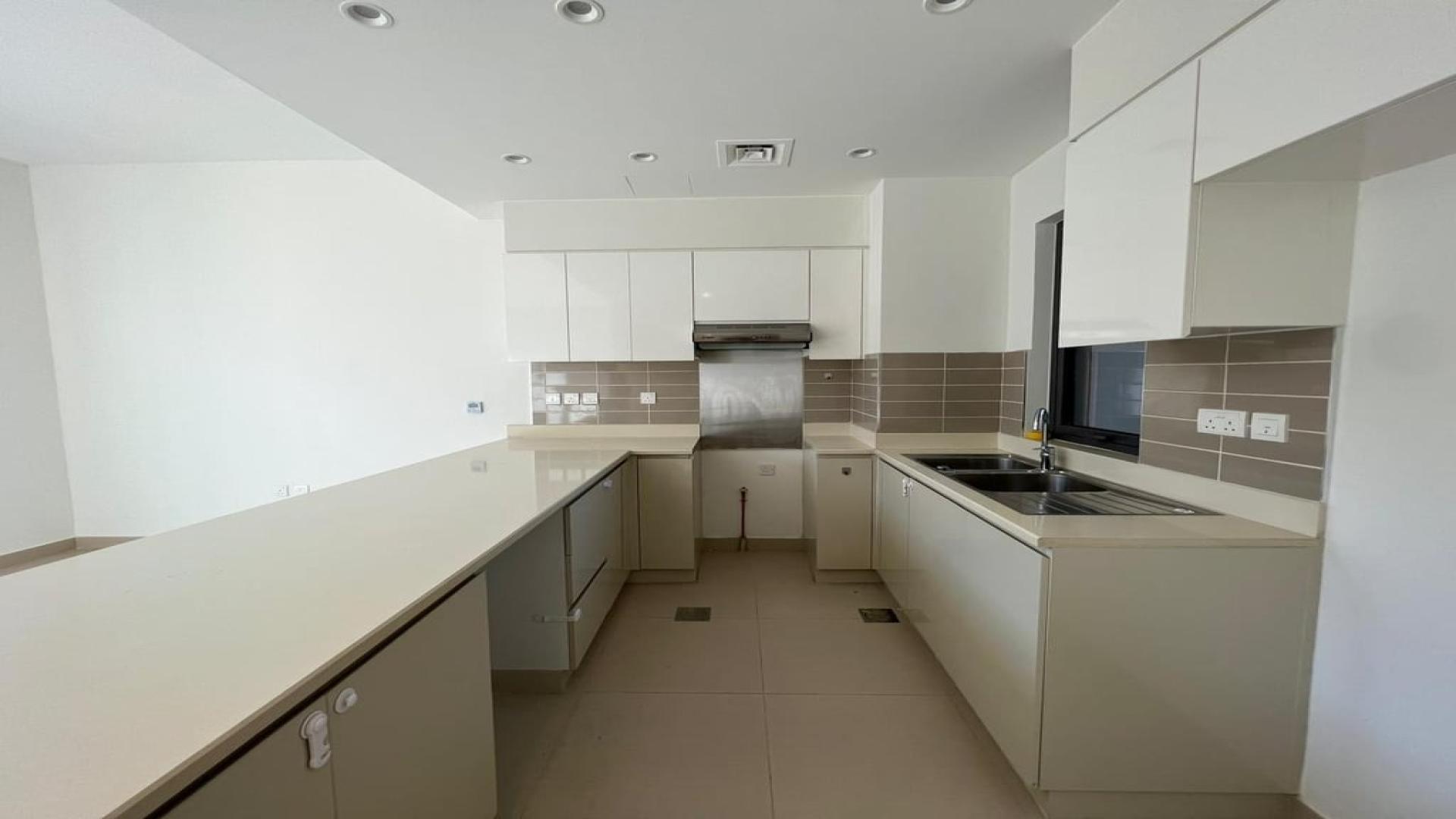 Modern open-plan kitchen and living area in Maple villa, Dubai Hills Estate