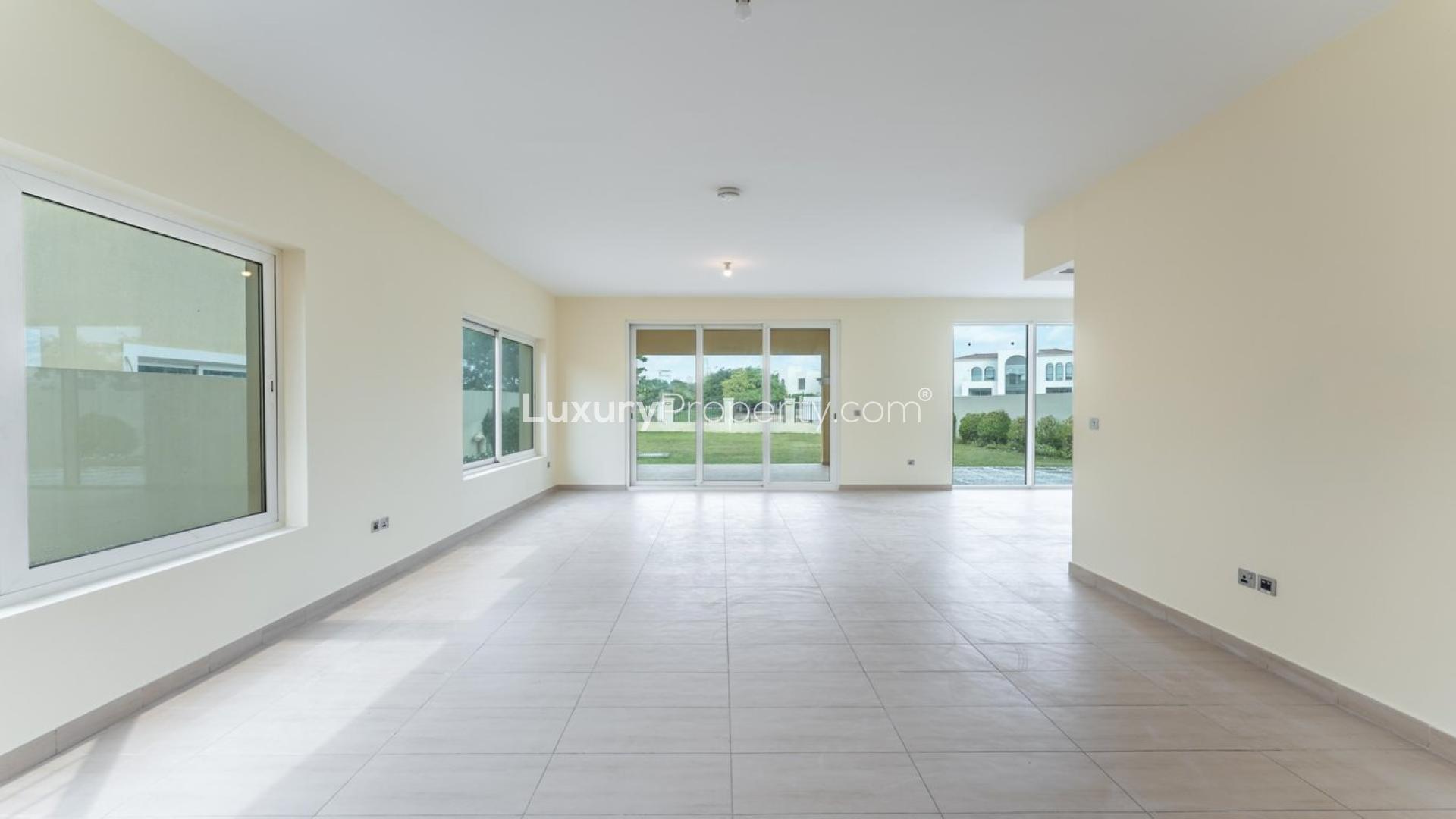 Spacious living area in Jumeirah Park villa with large windows and garden view