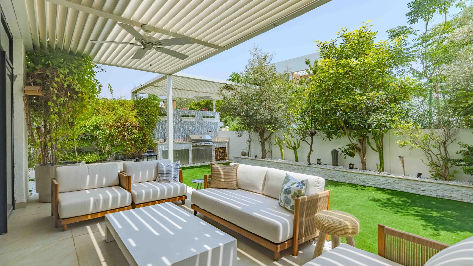 Elegant living room in upgraded villa, Jumeirah Golf Estates, with garden view and modern decor