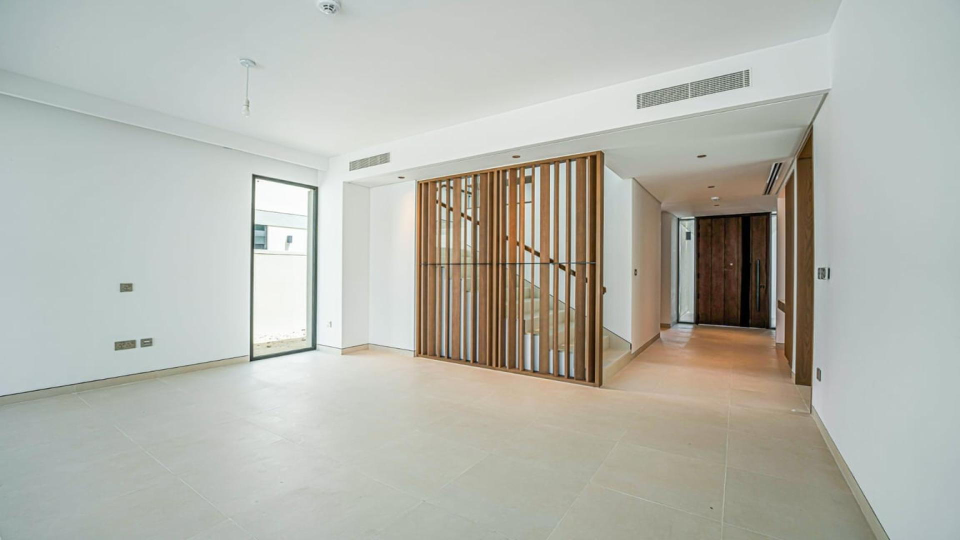 Brand new upgraded villa interior with staircase and sliding doors in Tilal Al Ghaf