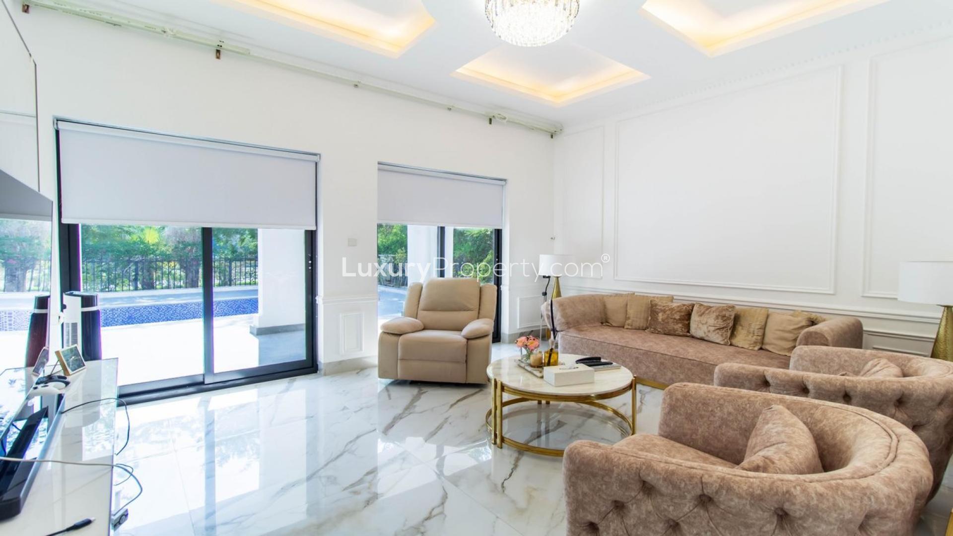 Luxurious sunlit living room in Vastu-compliant Jumeirah Islands villa with garden view