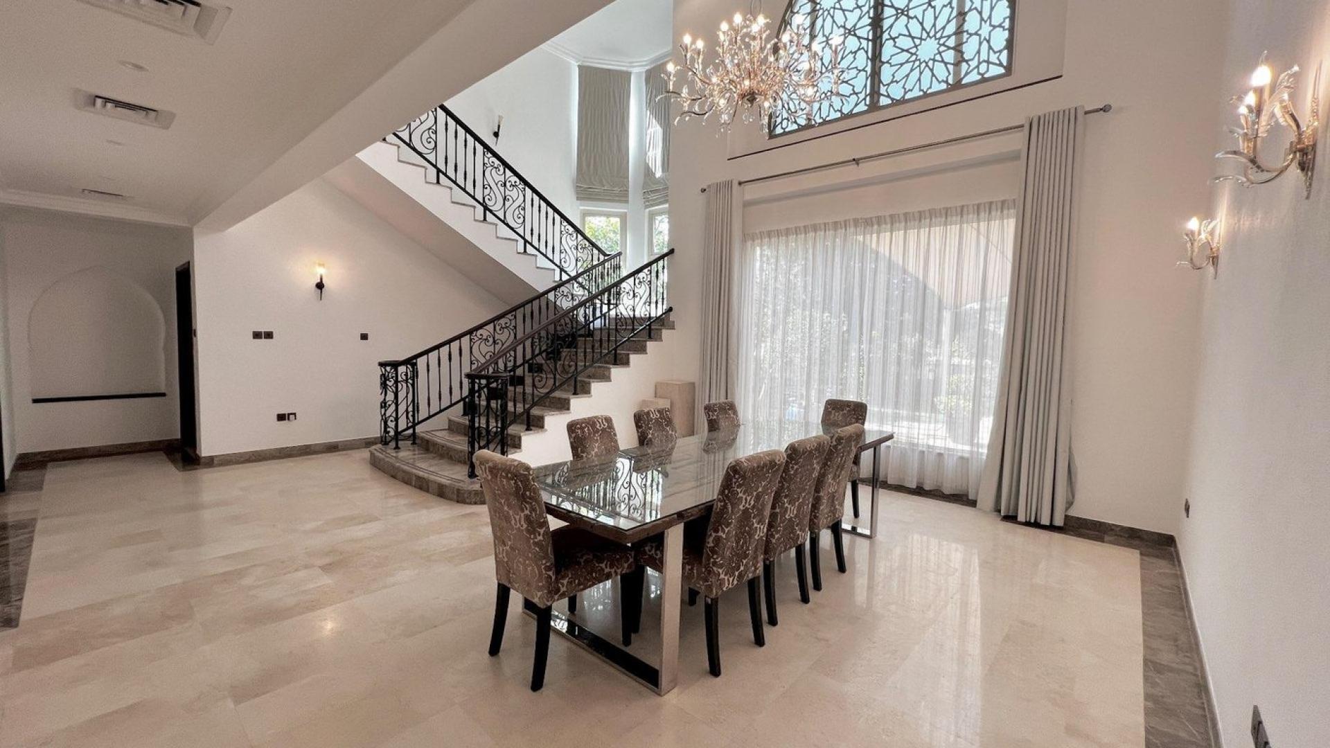 Outdoor pool area with shade sails at European Clusters villa, Jumeirah Islands