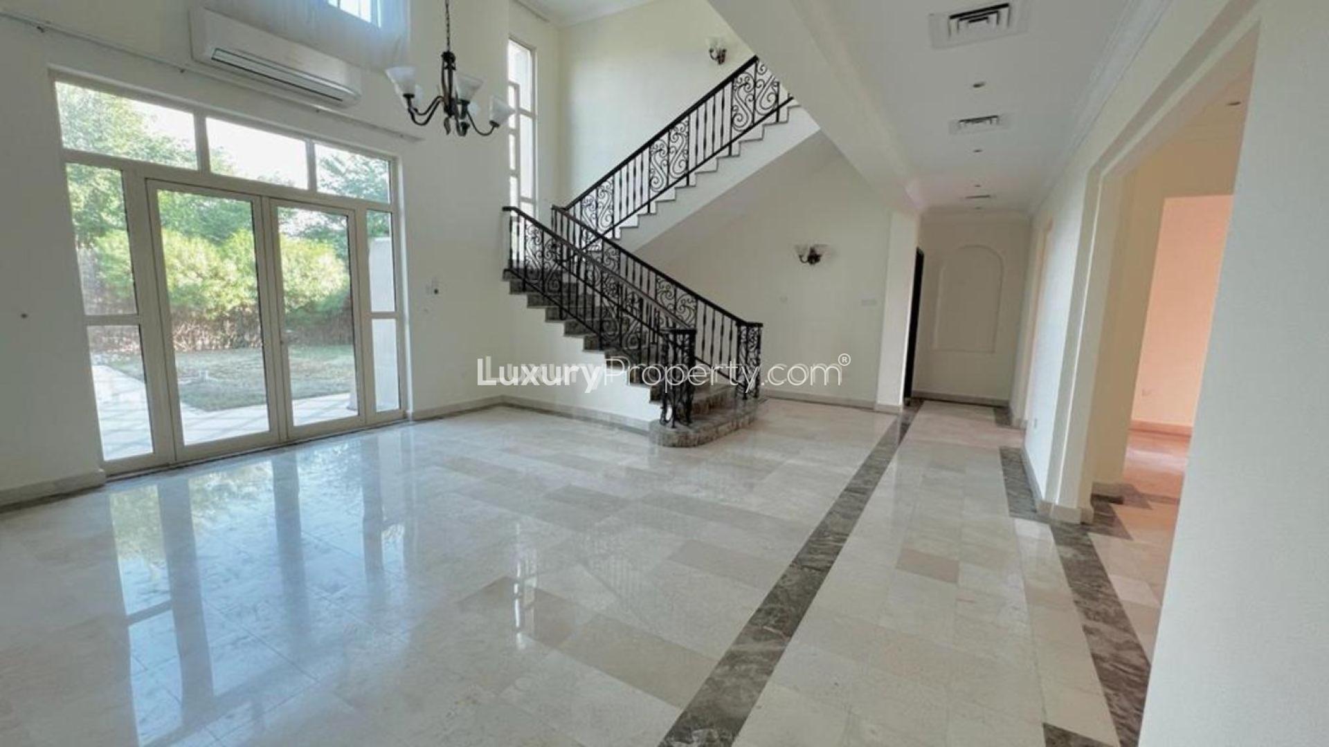Luxurious villa interior with elegant staircase and chandelier in Jumeirah Islands, Dubai