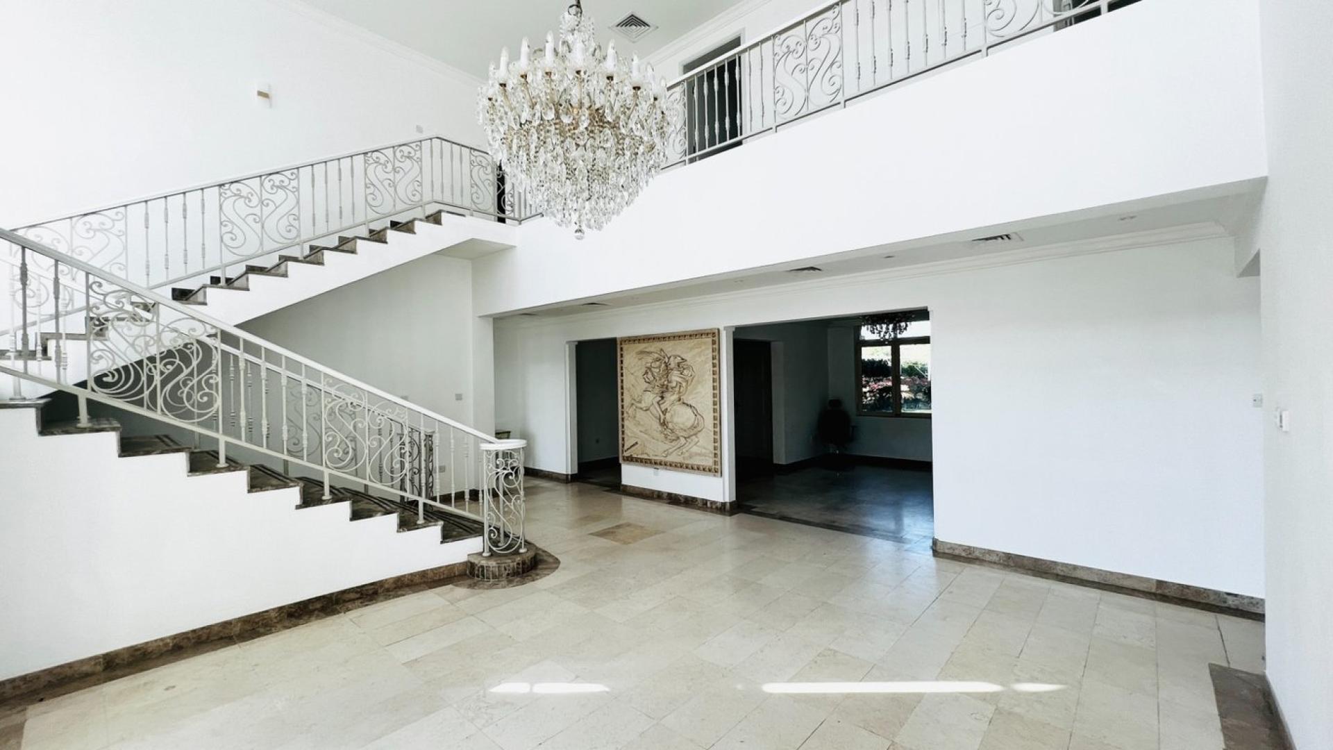 Luxurious villa interior with elegant staircase and large windows in Jumeirah Islands