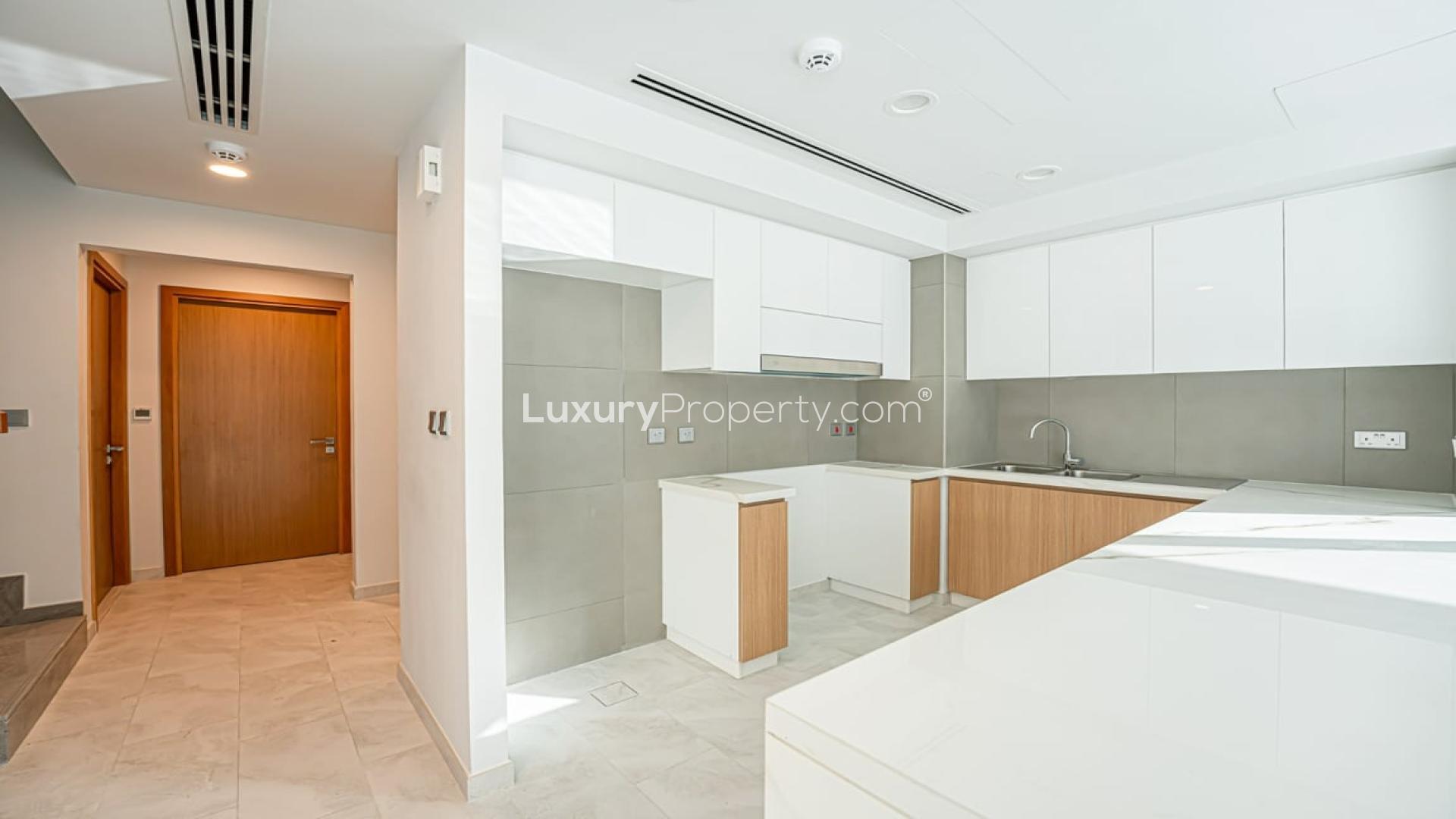 Modern kitchen with large windows in 4-bedroom villa, La Rosa, Dubai Land