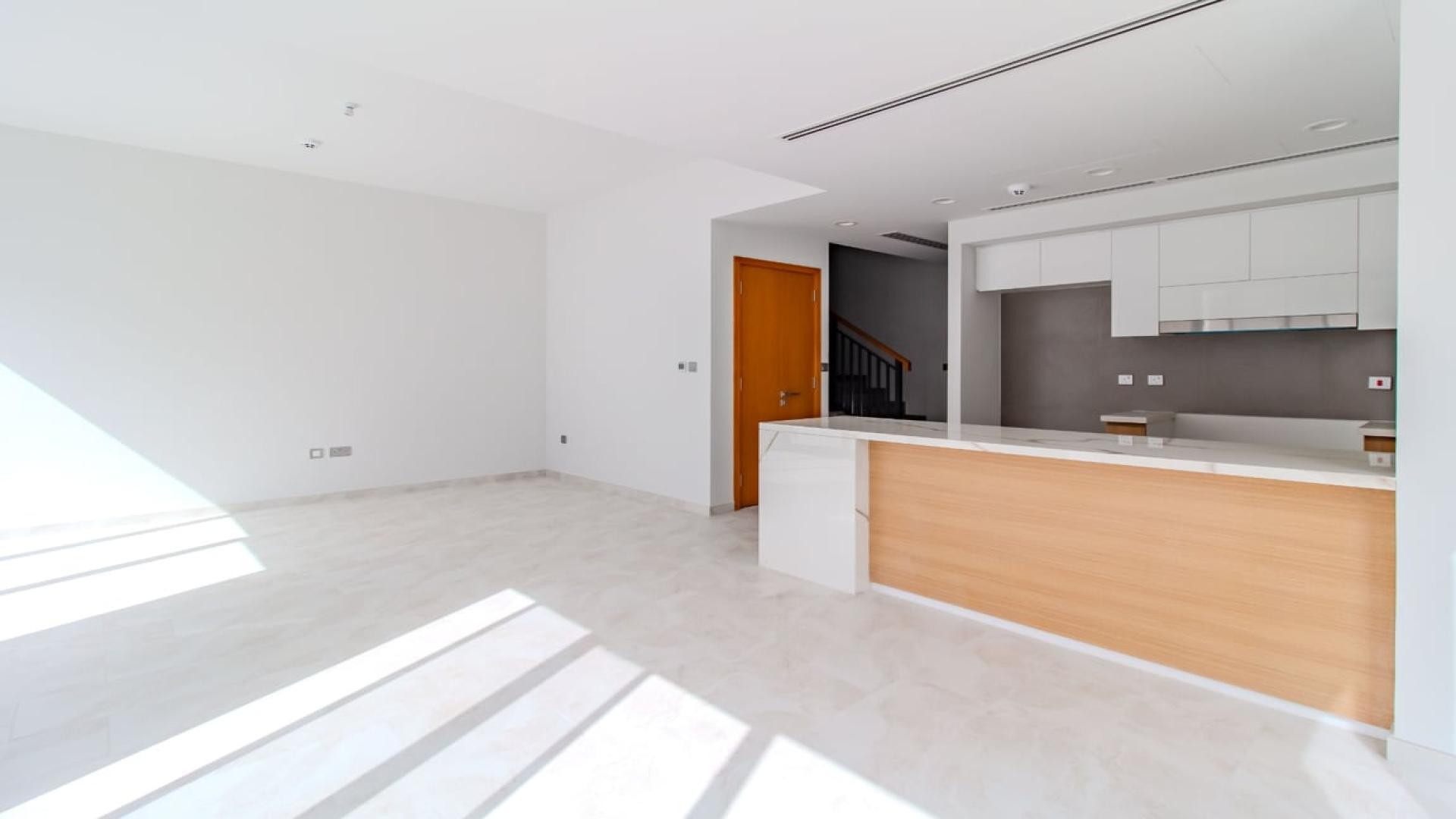 Bright living room with large windows in La Rosa 2 villa, Dubai Land