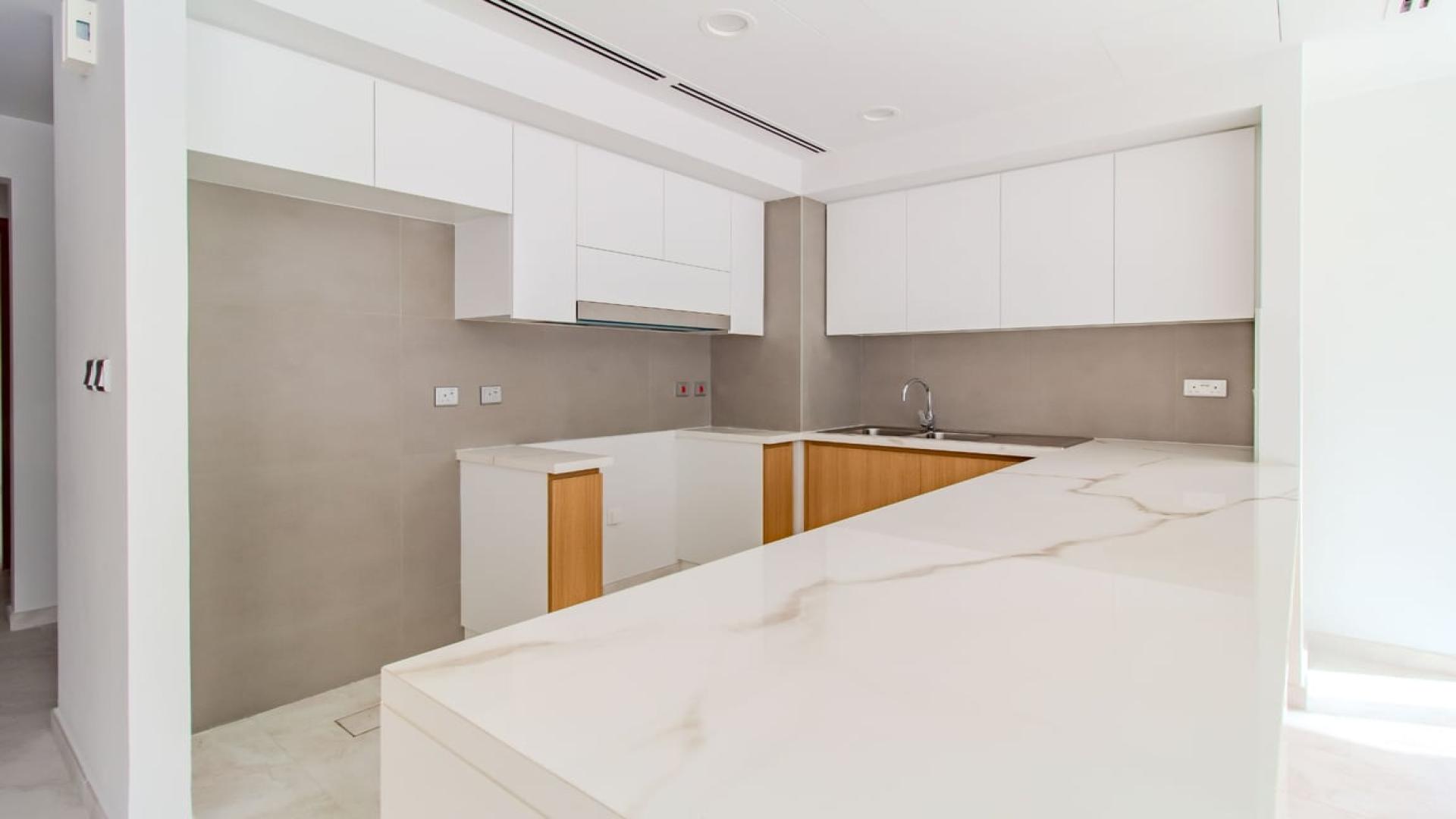 Bright living room with large windows in La Rosa 4-bedroom villa, Dubai Land